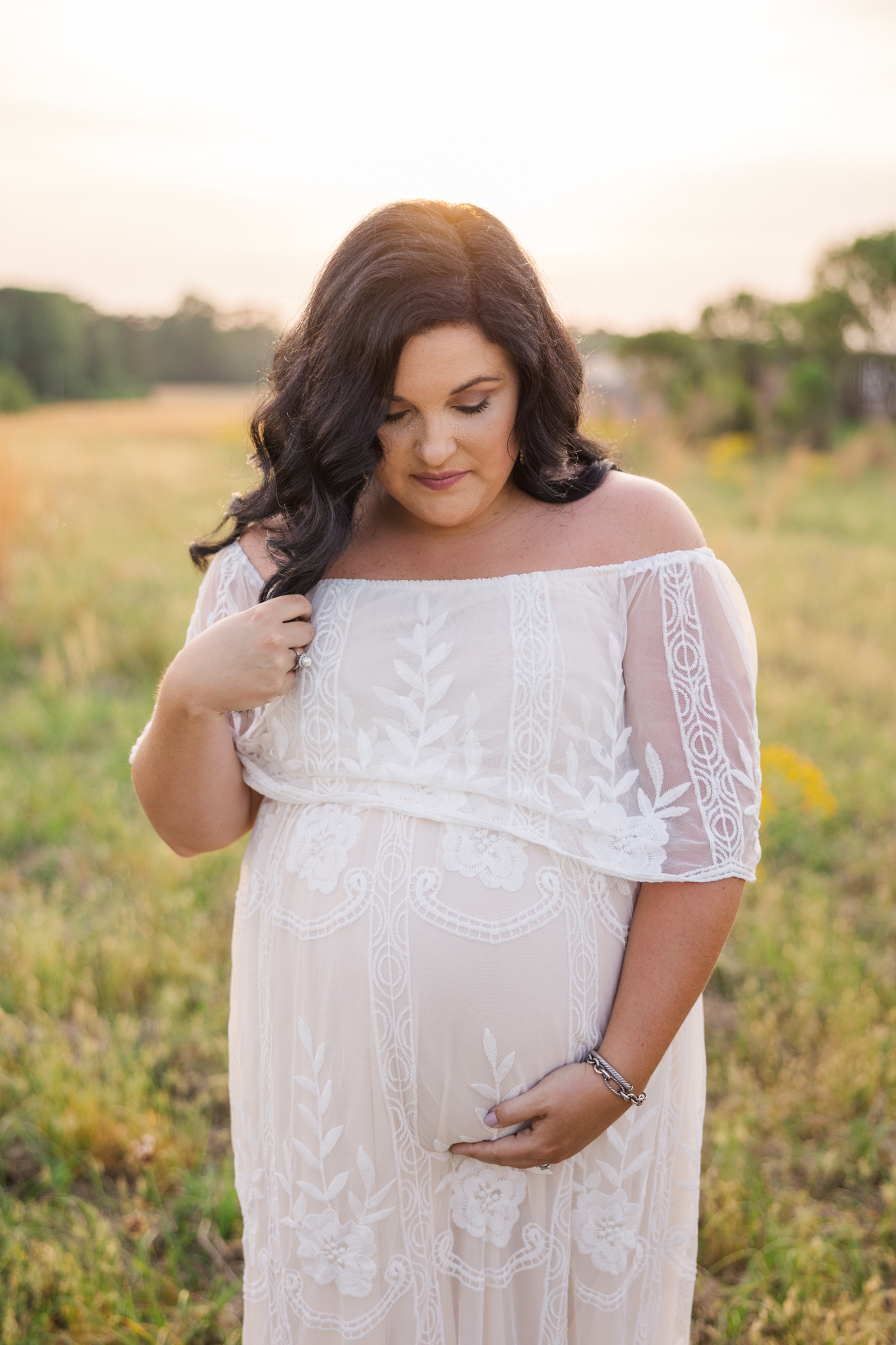 Expecting mom getting maternity photos in Augusta, GA at sunset.