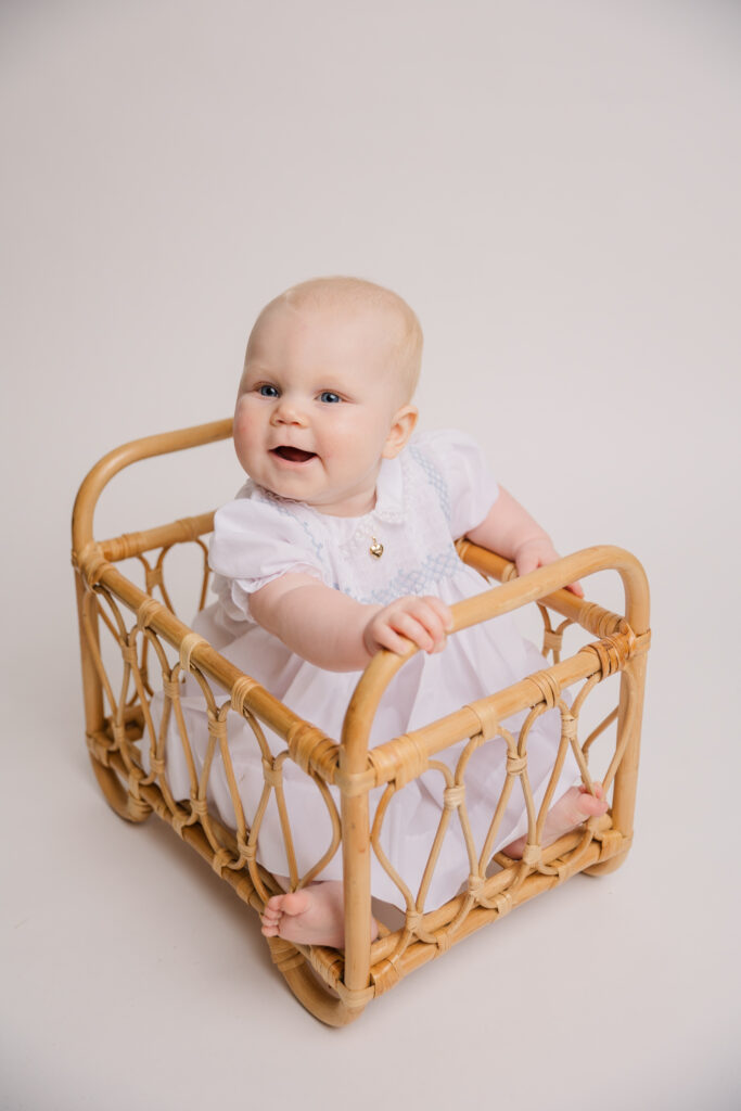 Studio milestone session with Molly Berry Photography. Girl is wearing a dress from Posh Tots.
