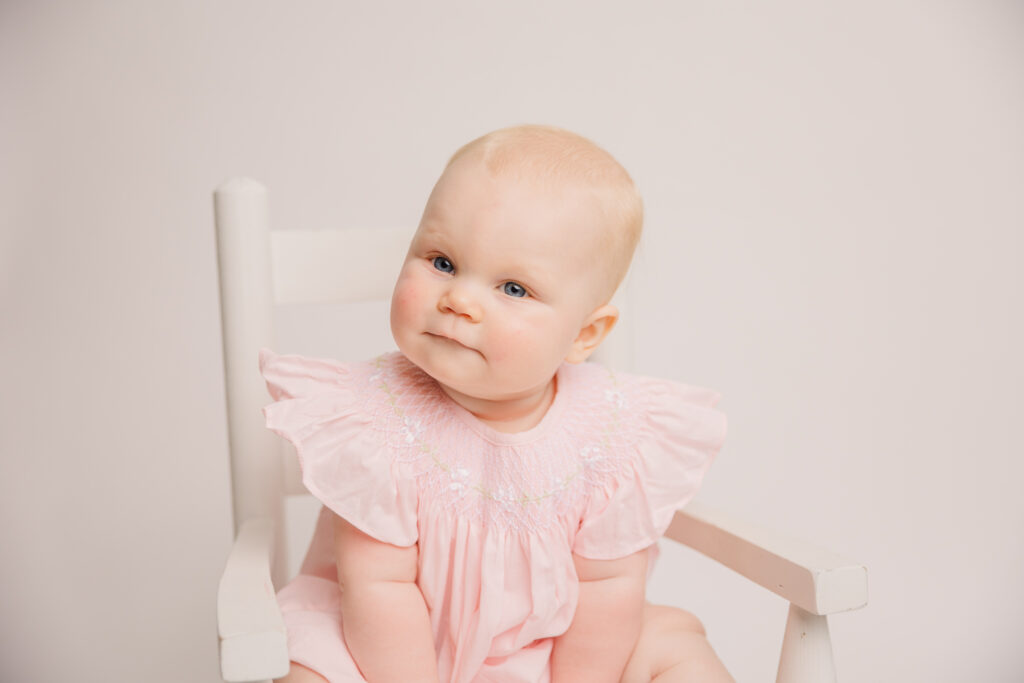 6 Month old girl wearing a pink Post Tots dress. Captured by Molly Berry Photography
