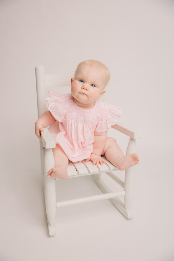6 Month old girl during her milestone session with Molly Berry Photography. Mom went to Posh Tots Augusta | Trendy Children's Boutique in Georgia to purchase the outfits for her session.