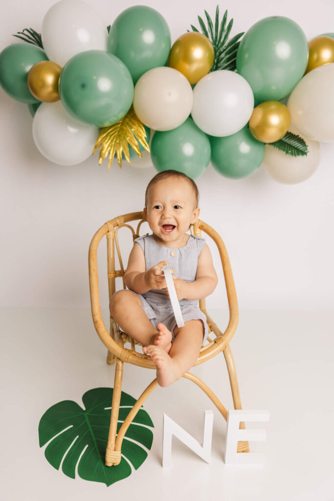 One Year Old enjoying his one year cake smash captured by molly berry photography in augusta, ga. Custom Cakes in Augusta GA
