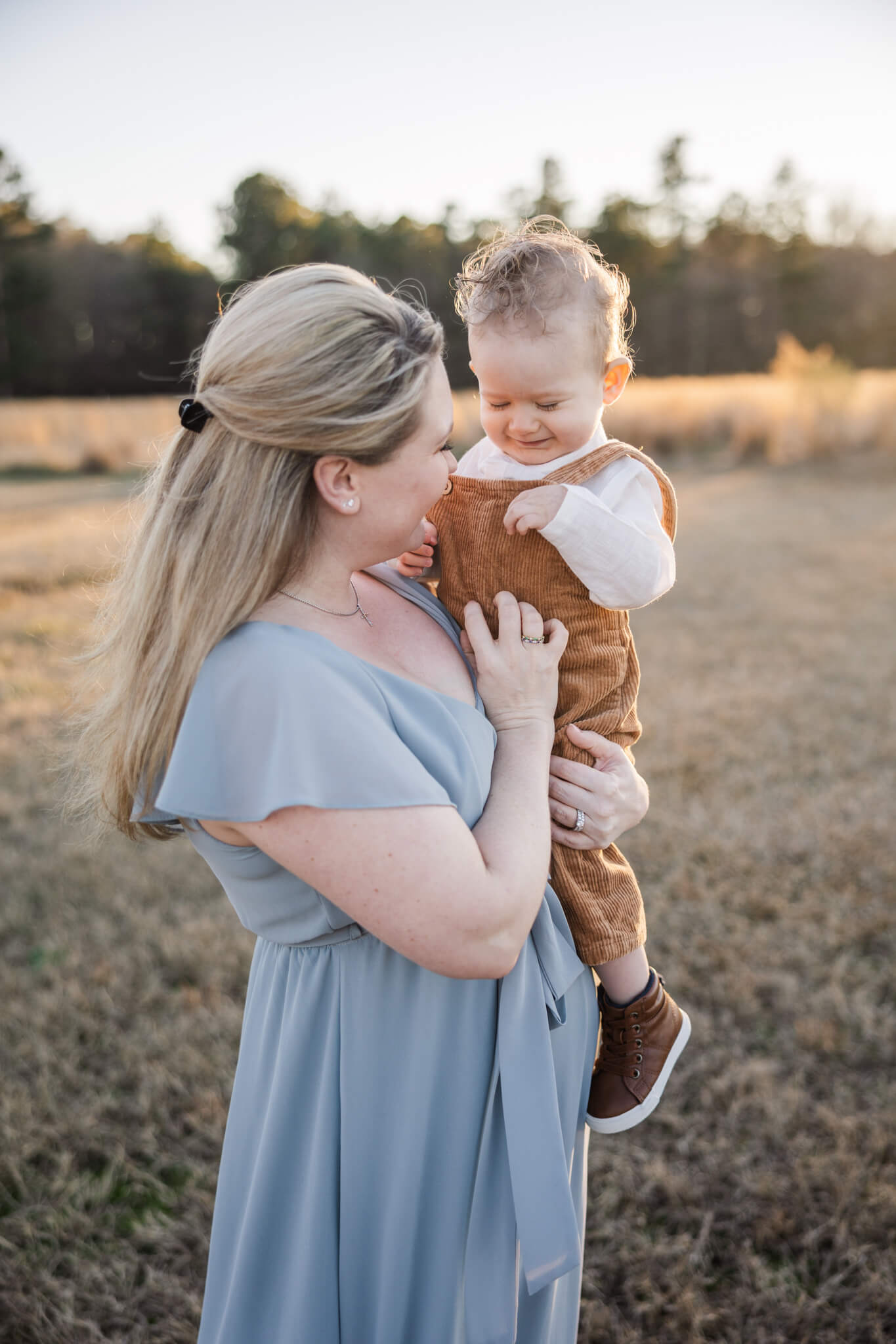 Mom tickling younger son during their family session. Mom and boy are wearing outfits from my client closet. spas augusta ga