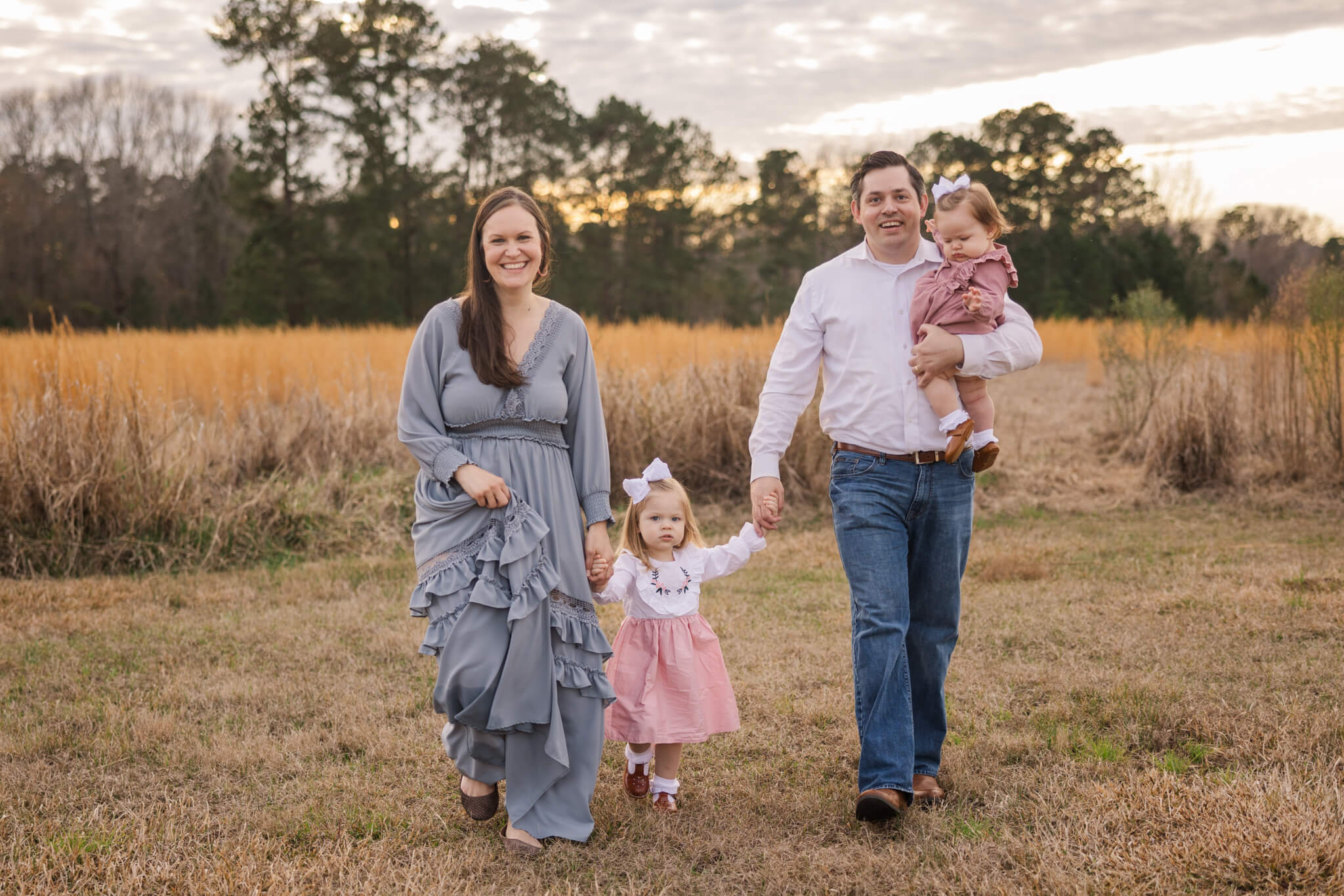 Family of four capturing a moment during their family session with Molly Berry Photography