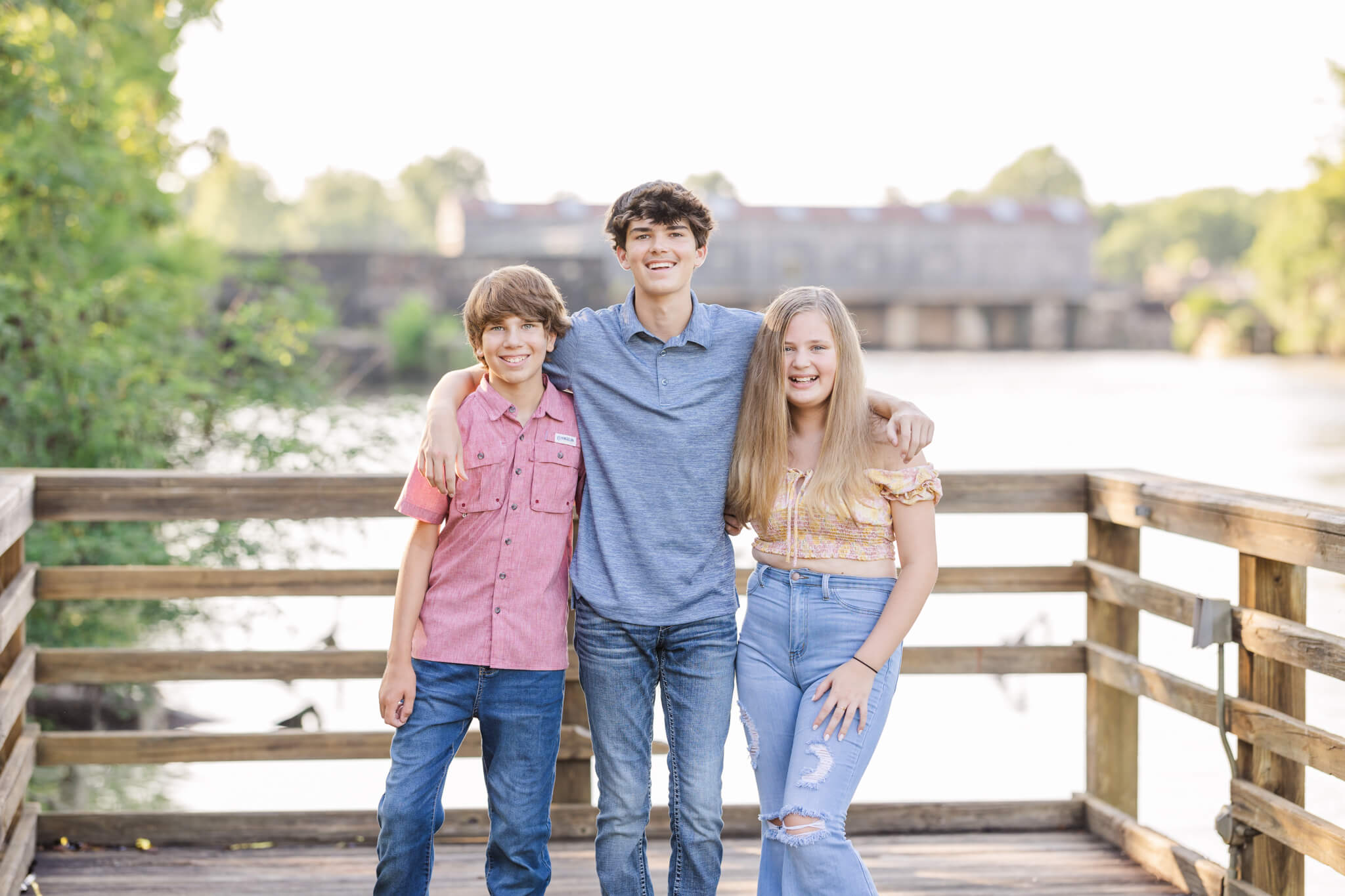Three siblings capturing a portrait during their milestone session at the savannah rapids. private schools in augusta ga