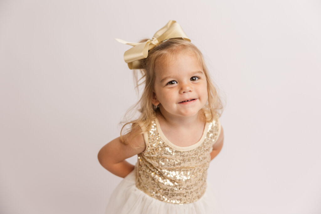 Two year old capturing portraits in her gymnastics dress during her milestone photographer session.
