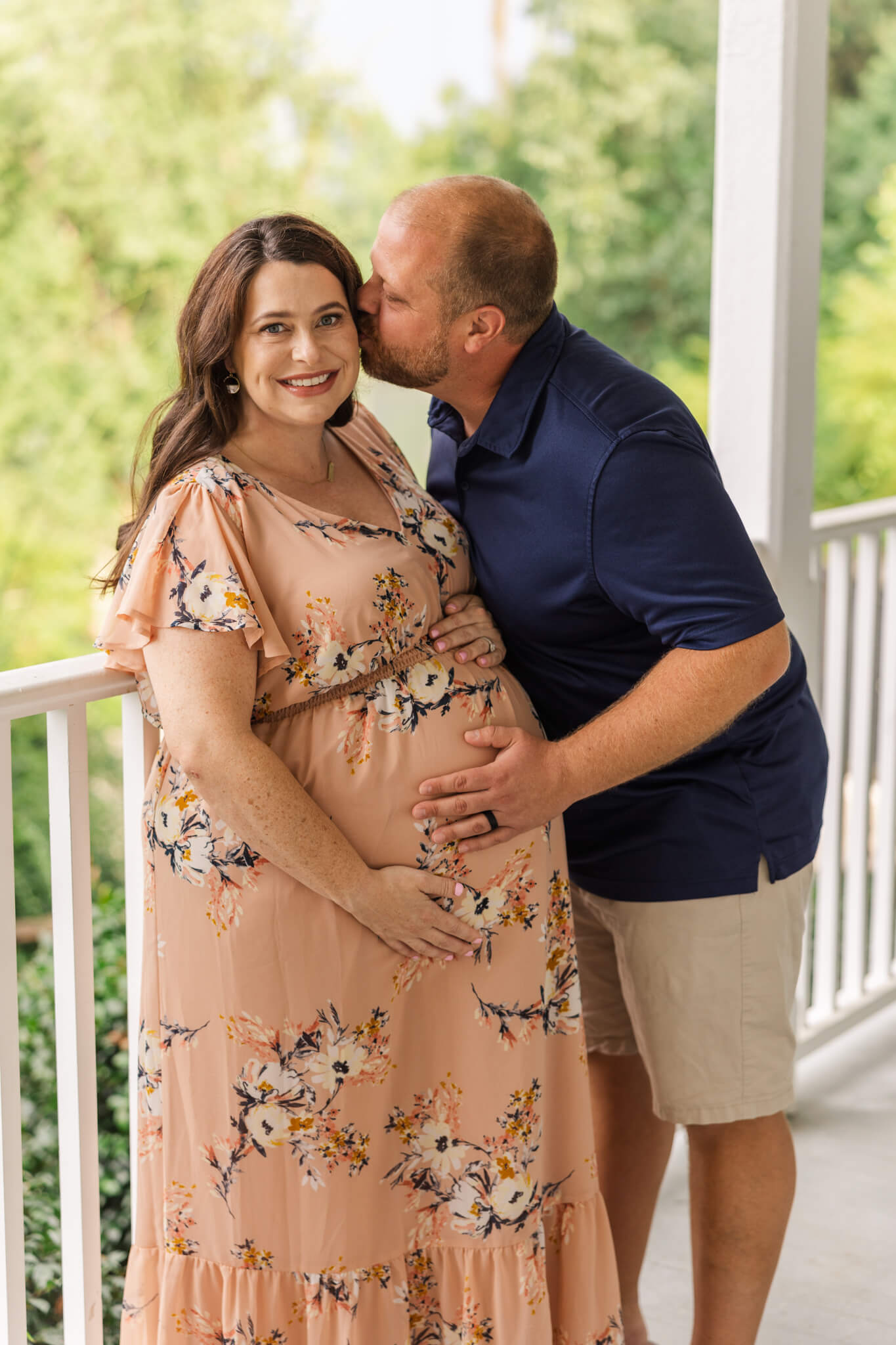Mom and dad share an intimate moment during their maternity photographer session captured by Molly Berry Photography. Midwives Augusta GA