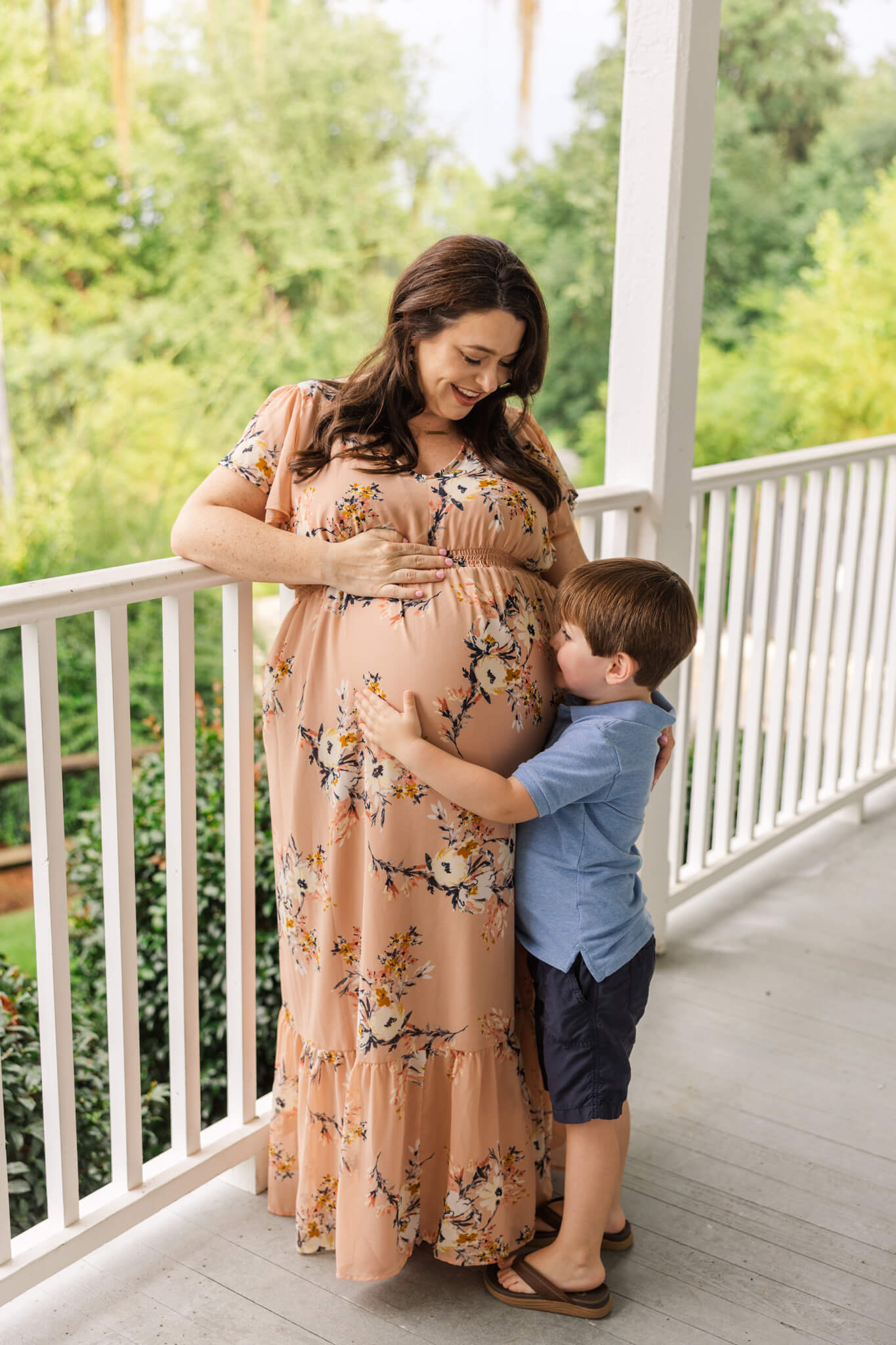 Big brother gives little brother a huge during their maternity photoshoot at the Savannah Rapids. Midwives Augusta GA