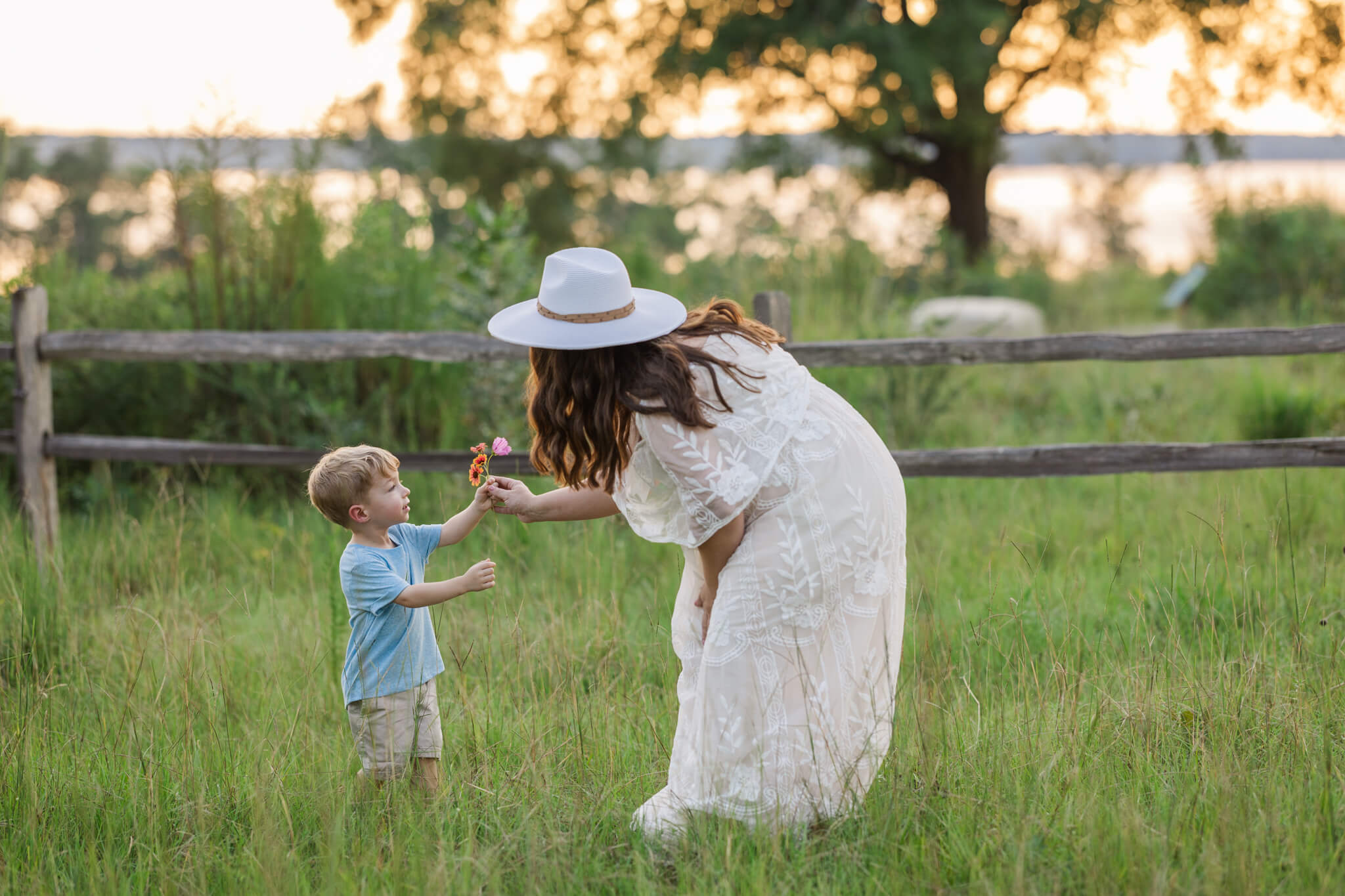 Expecting mom getting flowers from her little boy during their maternity session captured by molly berry photography. 