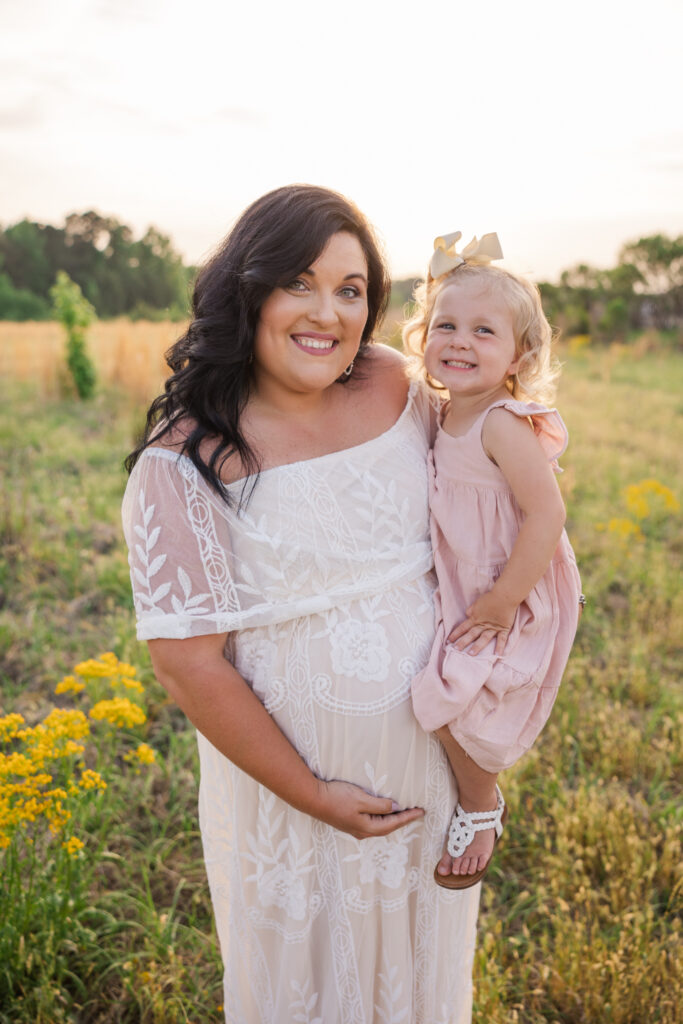 Expecting mom and daughter capturing a sweet moment together at their maternity session in Grovetown. Captured by Molly Berry Photography.