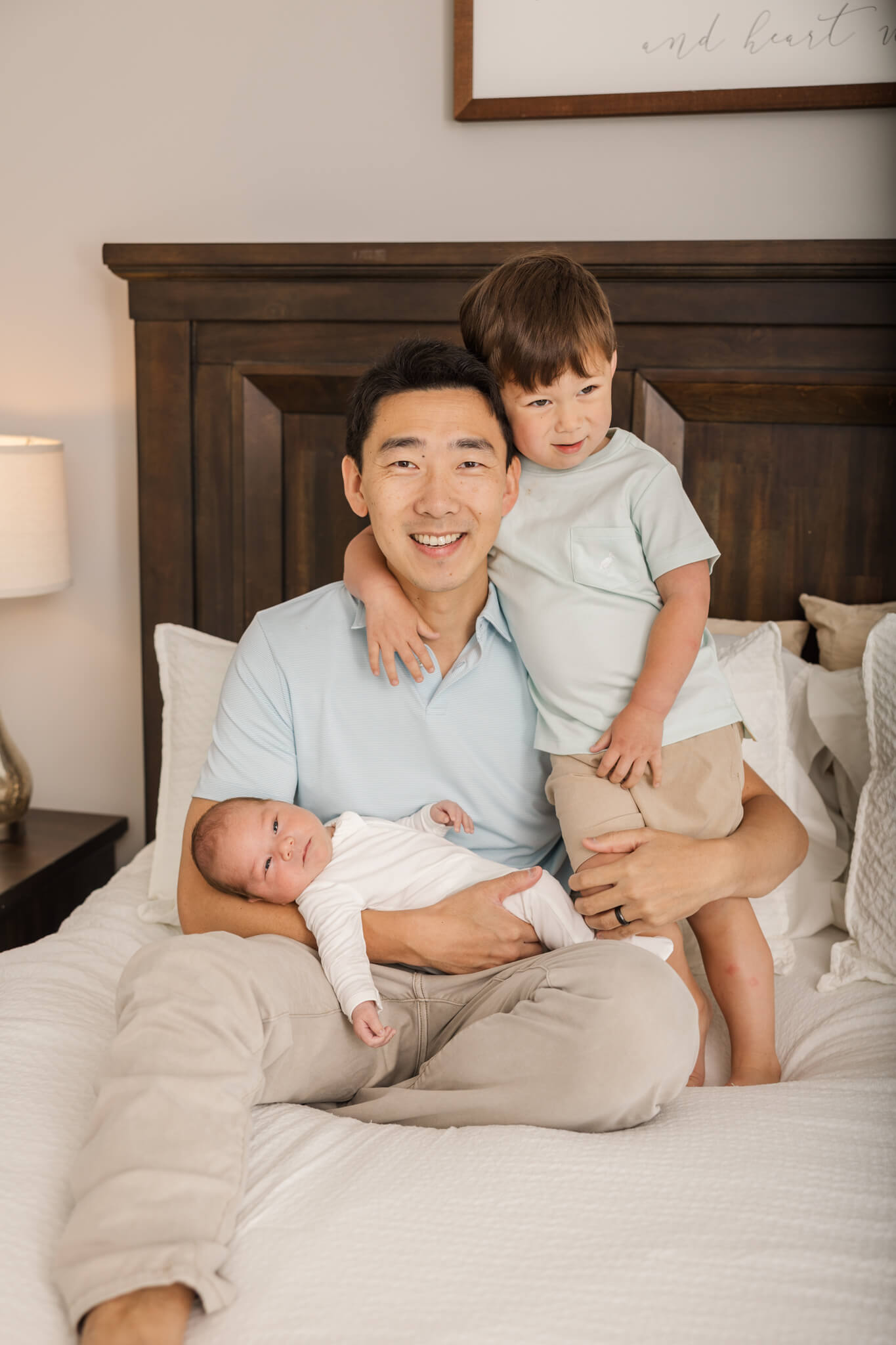 Dad and his boys captured during their in home newborn session. The Swank Company