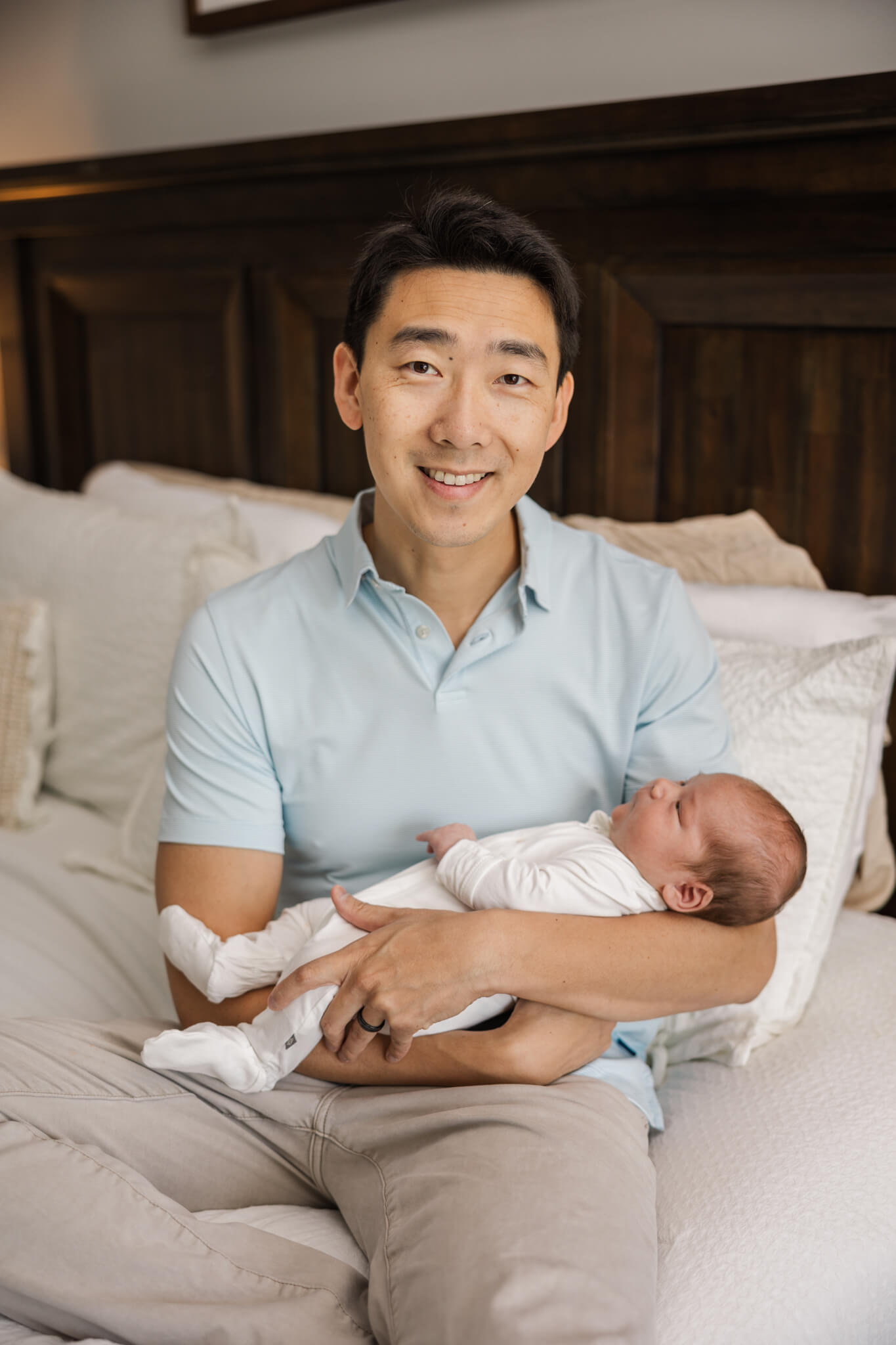 Quiet moment of dad with his newest son during their in home newborn session. The Swank Company