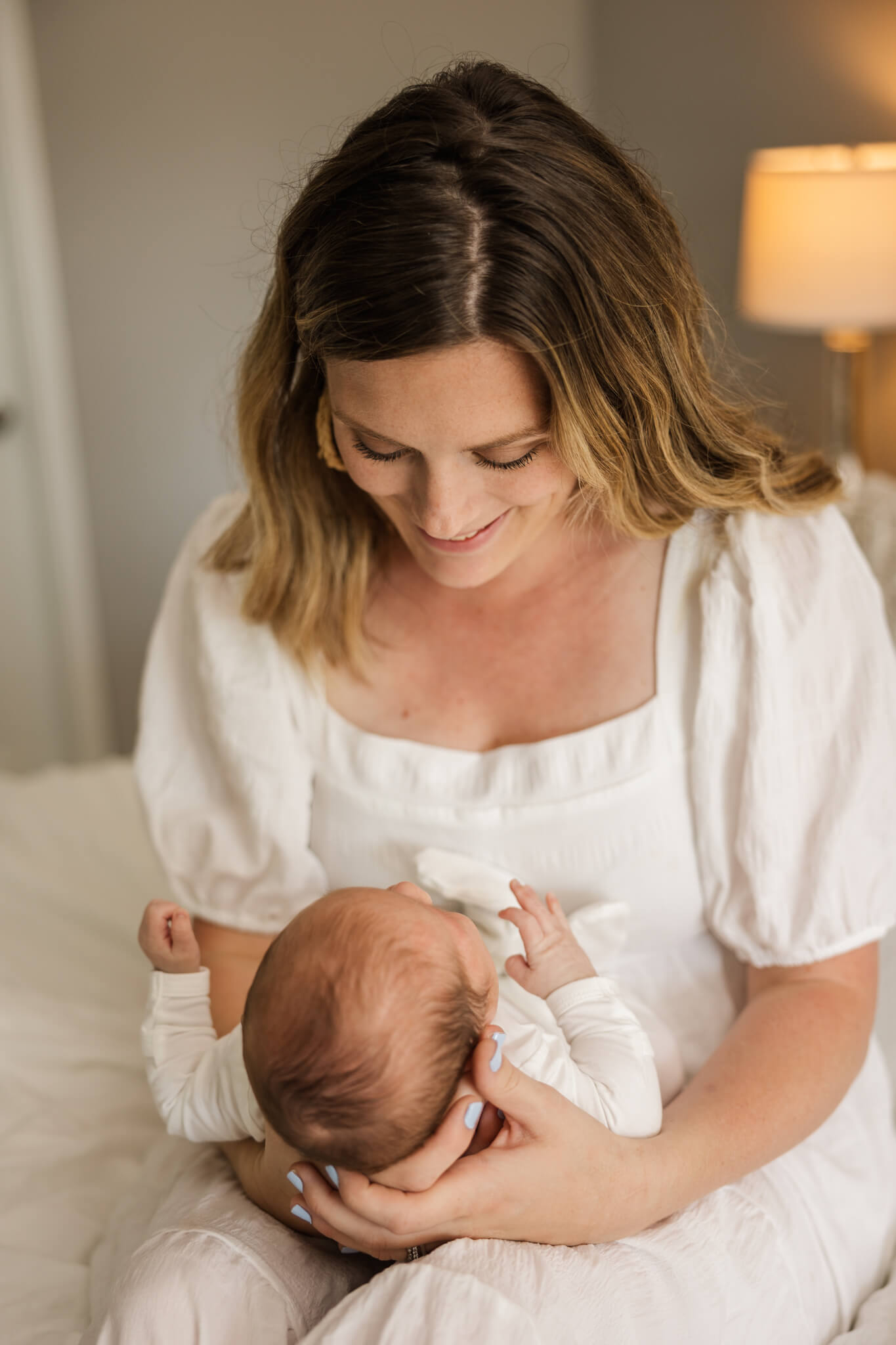Mom adoring her newest baby boy captured during their in home newborn session. The Swank Company