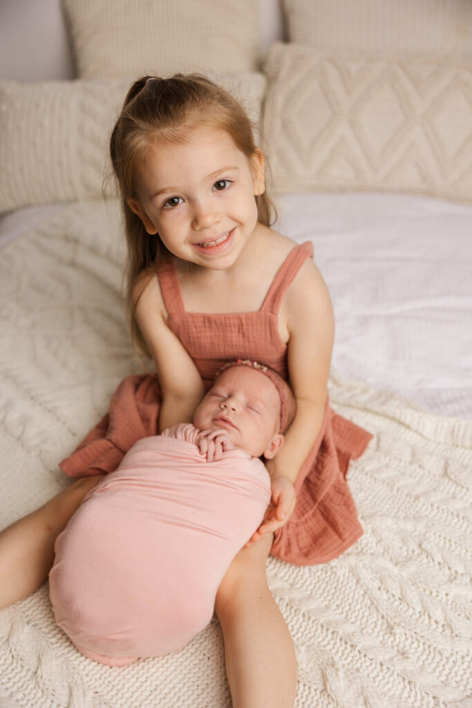 Big sister wanted a moment to capture a picture with her new baby sister. 