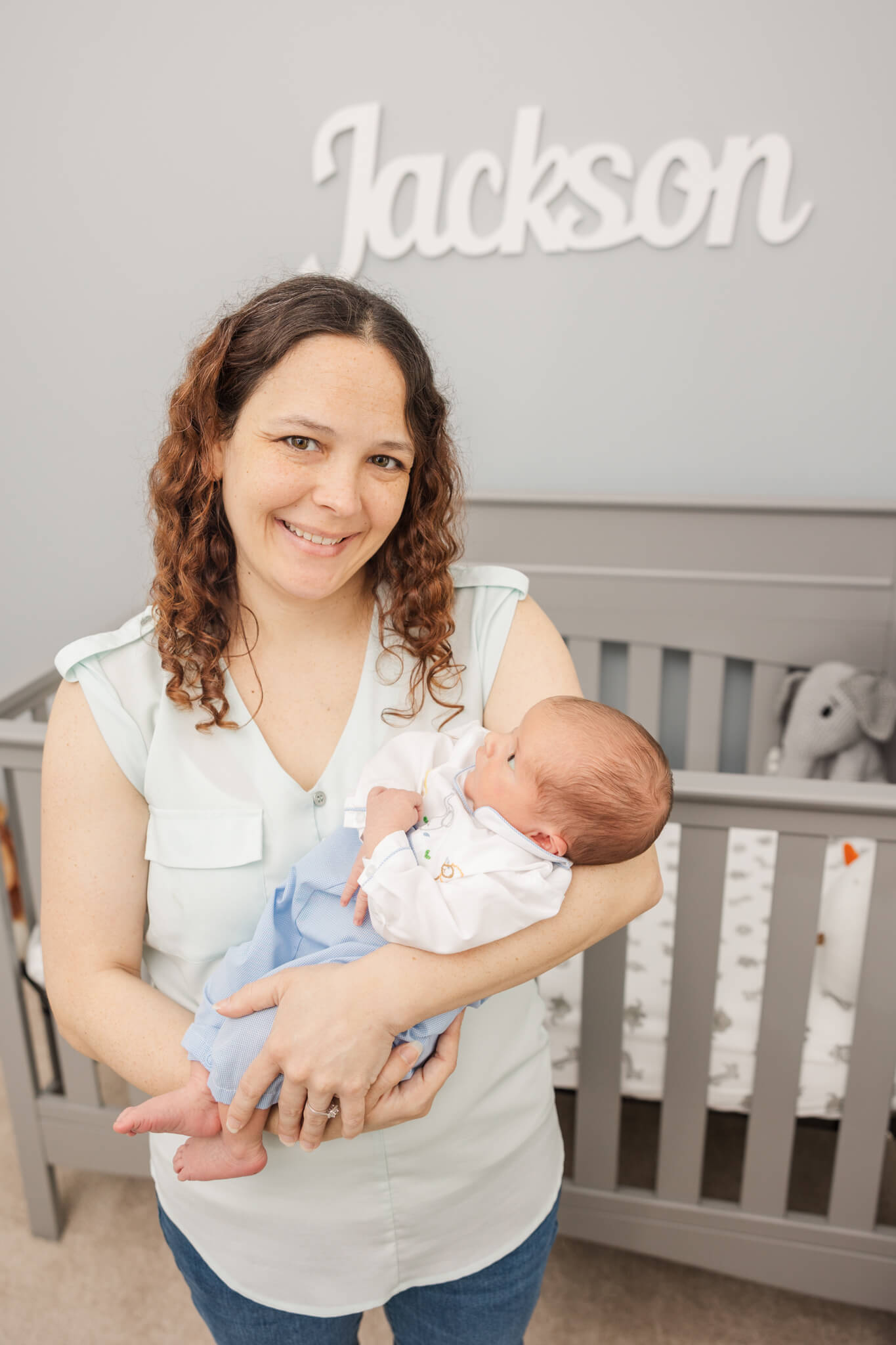 new mom holding her newborn in his nursery Doulas Augusta GA
