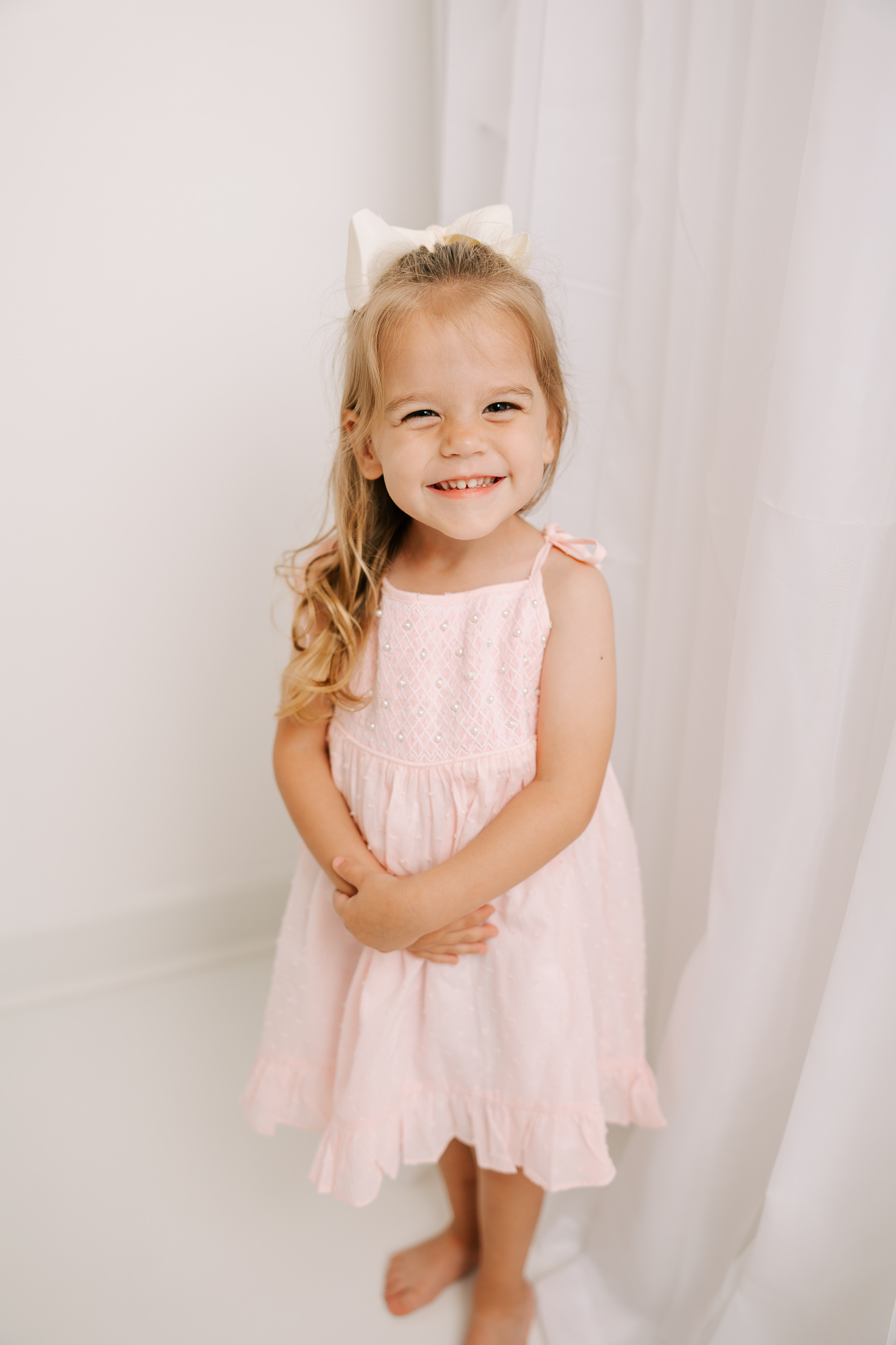 During in-studio session captured a gorgeous 3 year old wearing a pink dress from client closet.  Augusta Christian School.