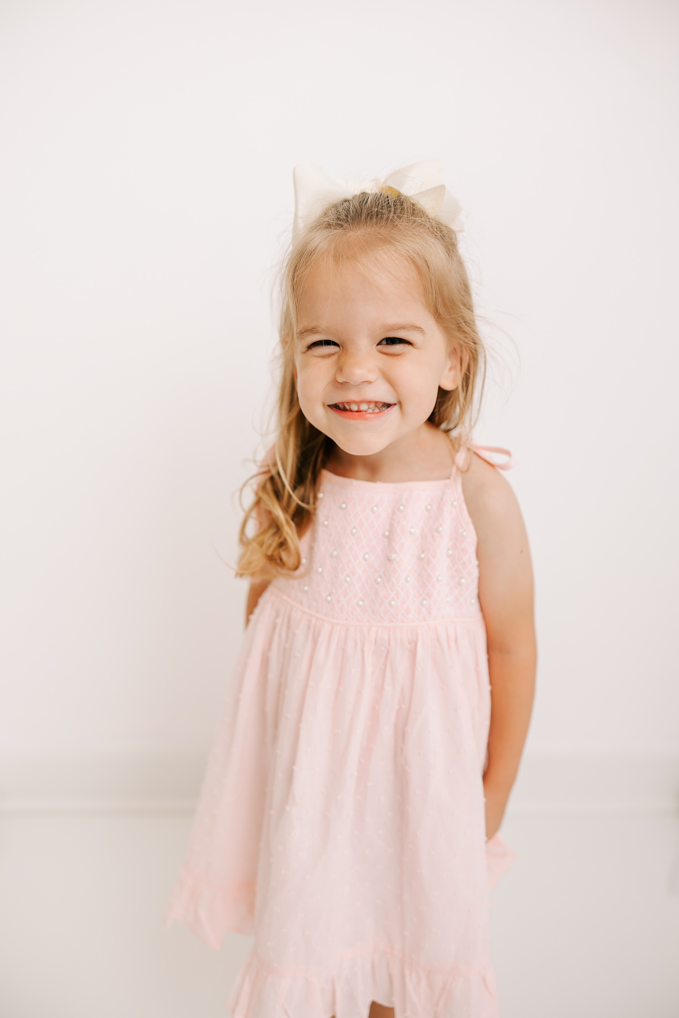 Captured 3 year old girl showing off her teeth during photography session with Molly Berry Photography. 