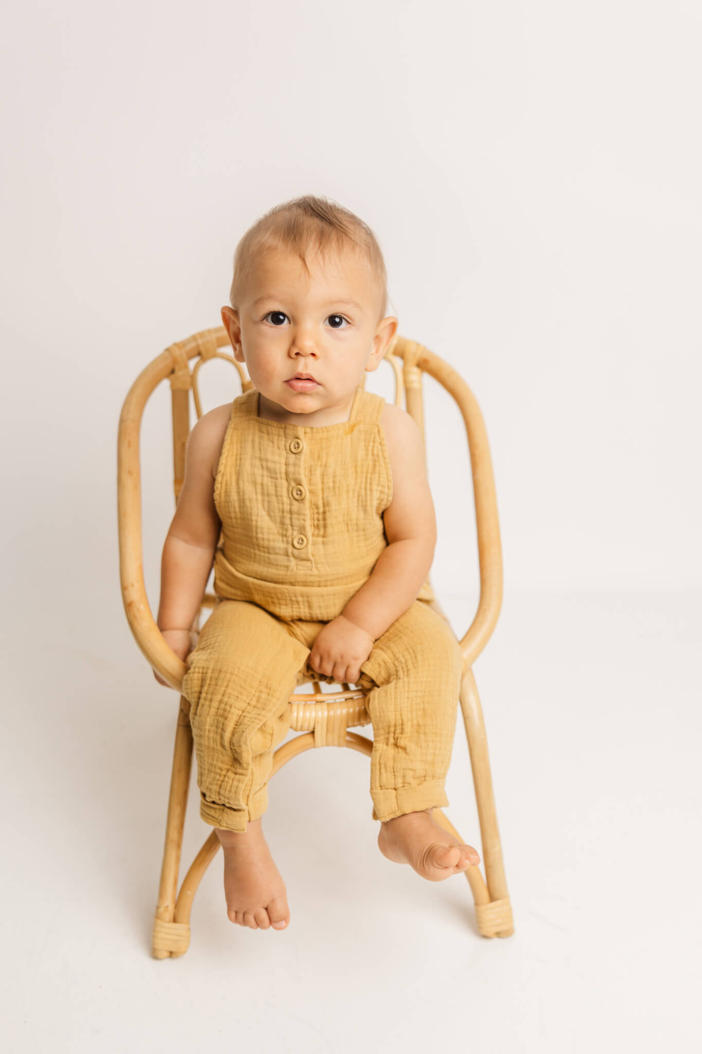 Little boy in yellow jumper.