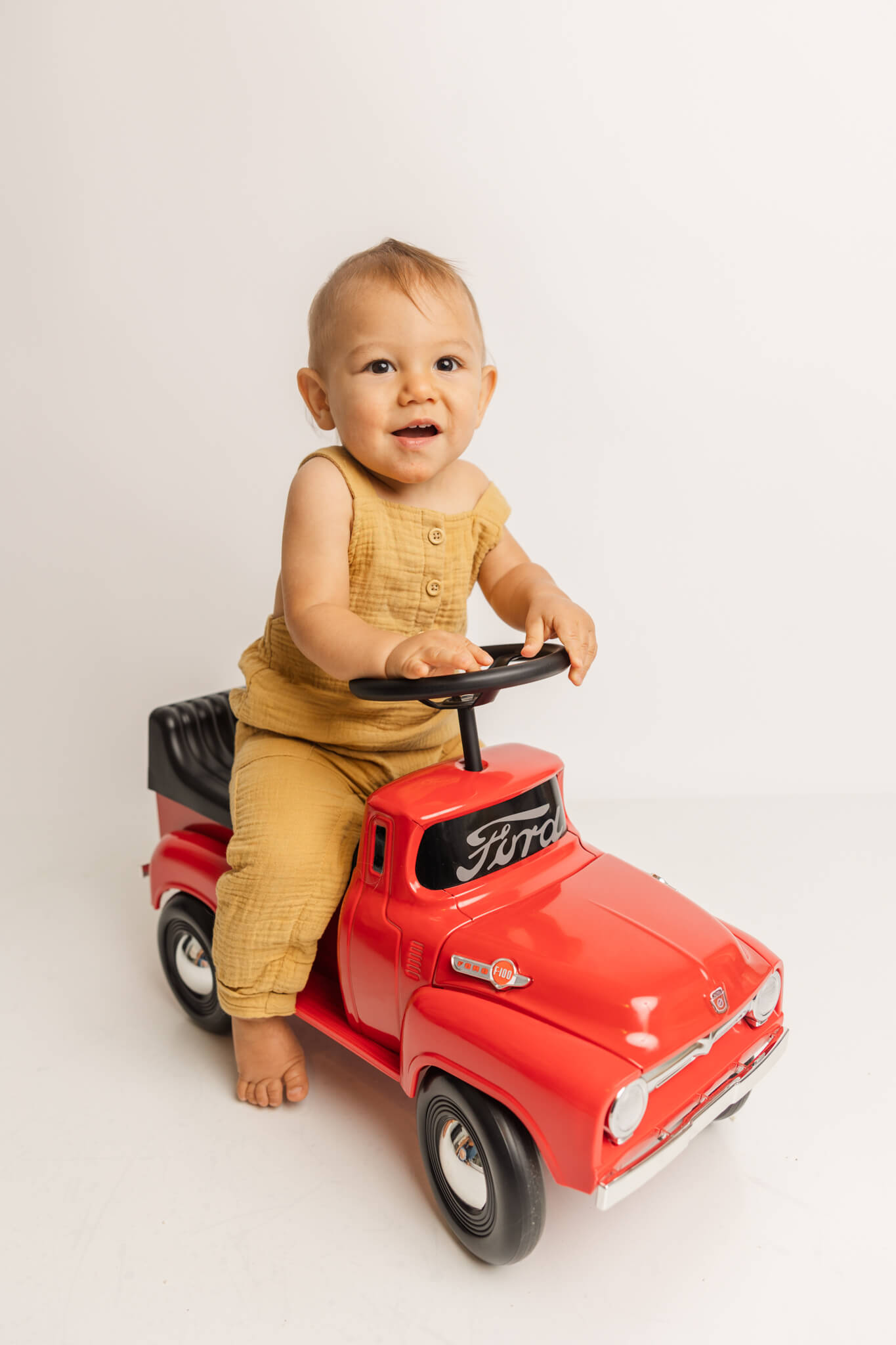 One year old on red truck