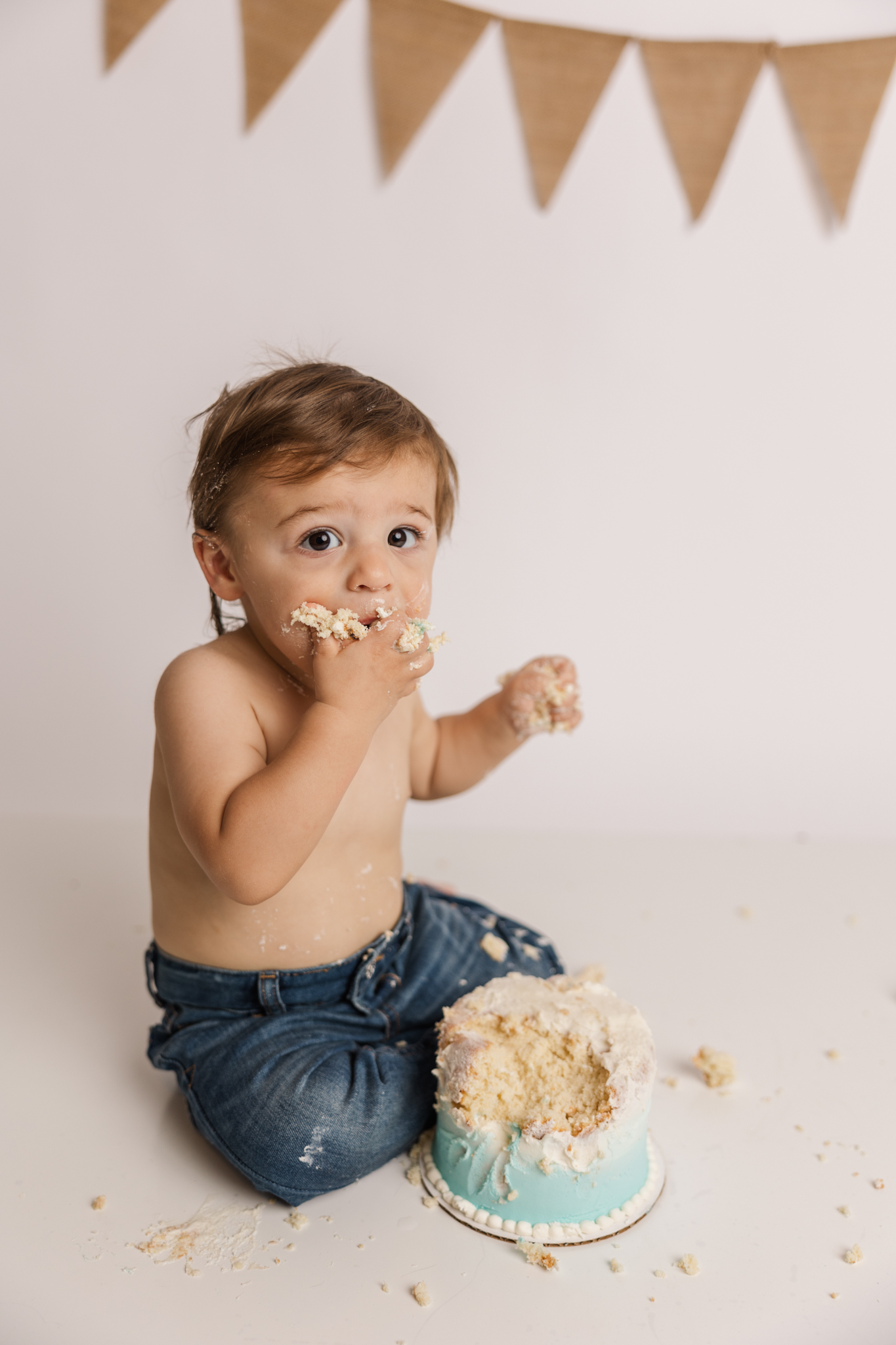 One year old eating birthday cake