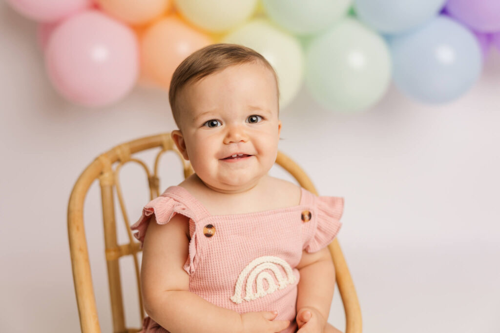 One year old girl in pink jumper