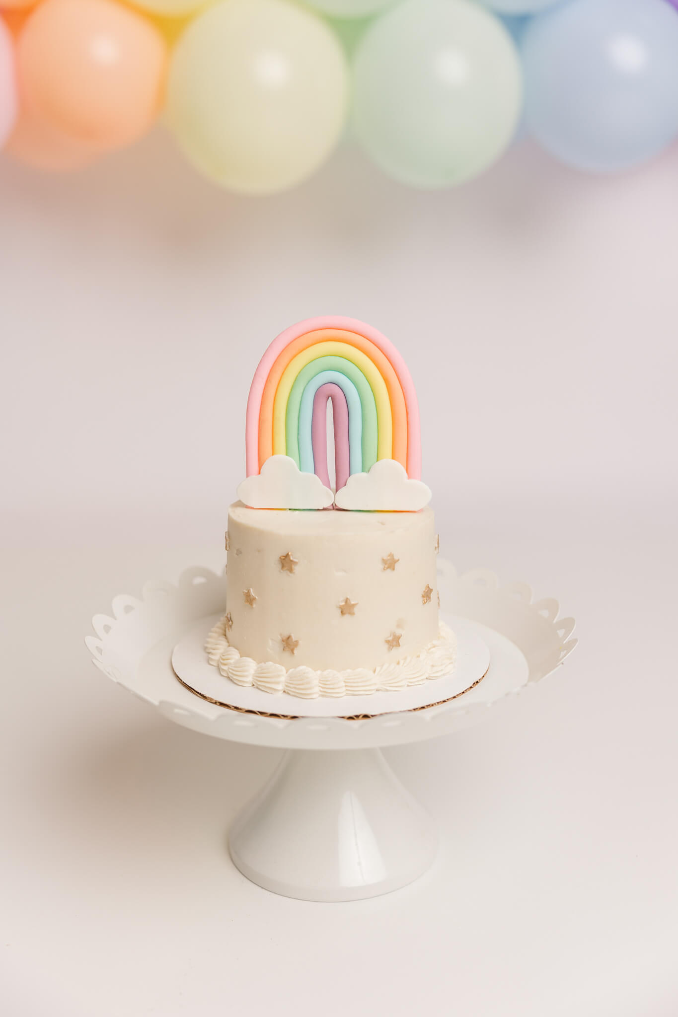 Rainbow topper on cake for 1 year old cake smash session.