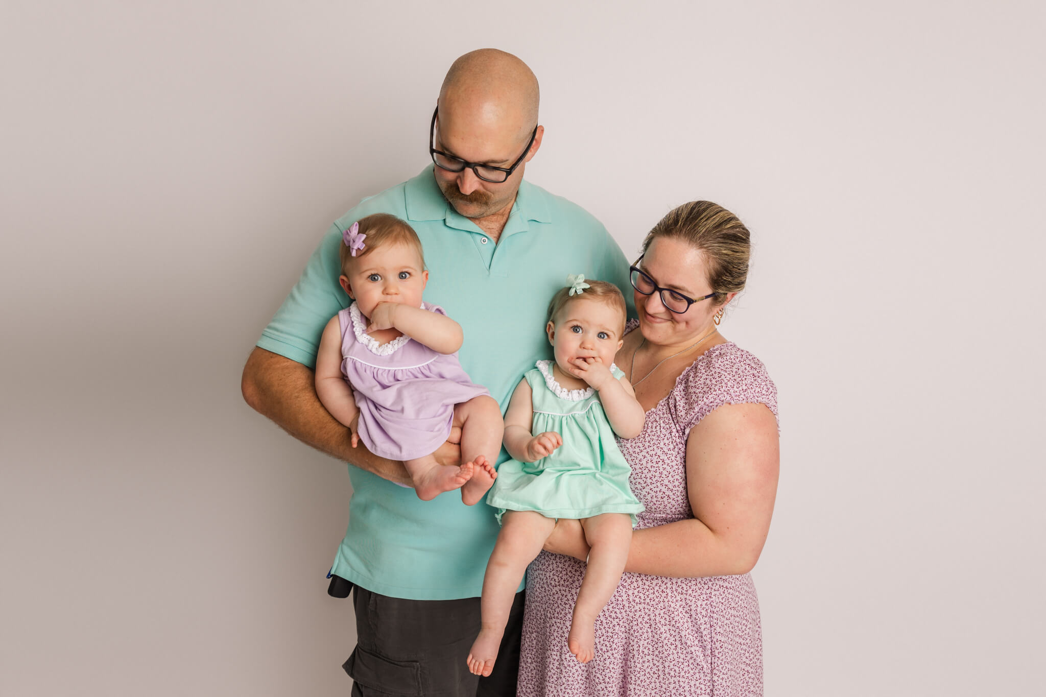 new family of four with twin girls in teal and purple outfits North Augusta Pediatrics