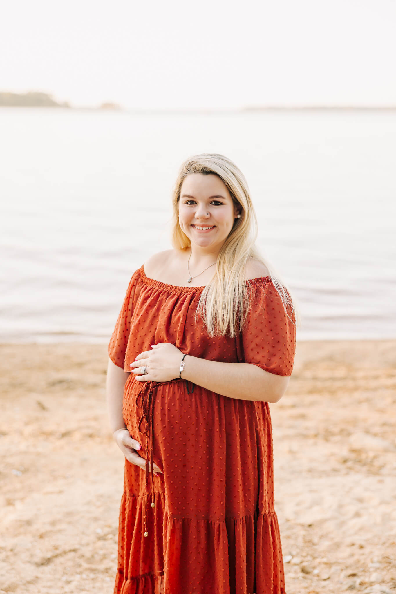 Expecting mom holding her belly during her augusta maternity photography session. Client featured in the Local venues to Host a Baby Shower in Augusta blog by Molly Berry Photography