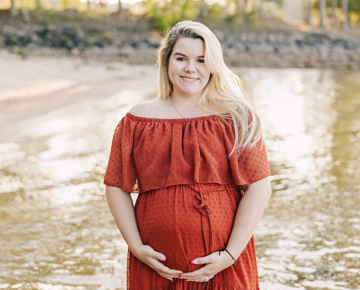 Pregnant mom holding her belly during her maternity session. Mom is wearing a rustic baltic born dress from my client closet.