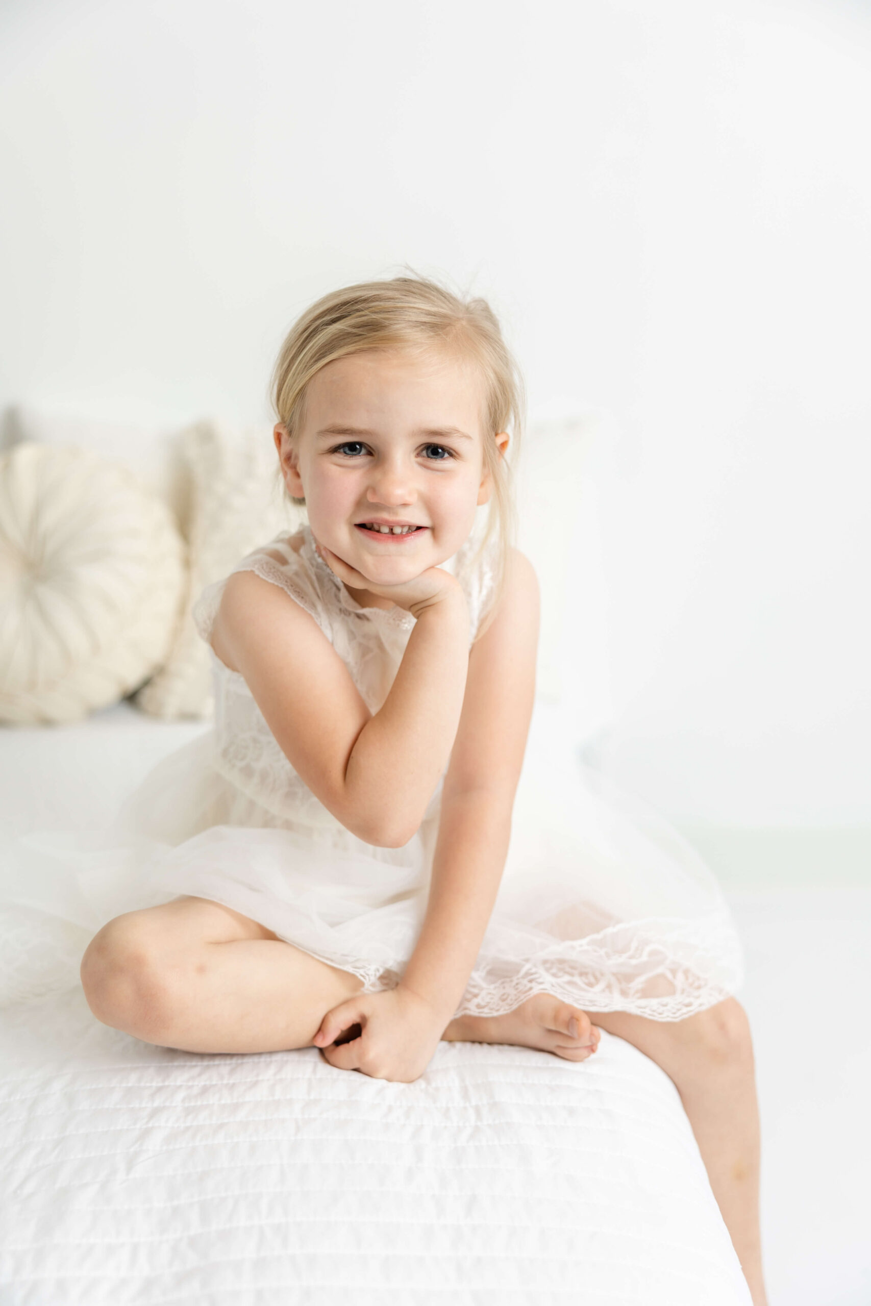 Captured 4 year old girl in white lace dress during child portrait session. 