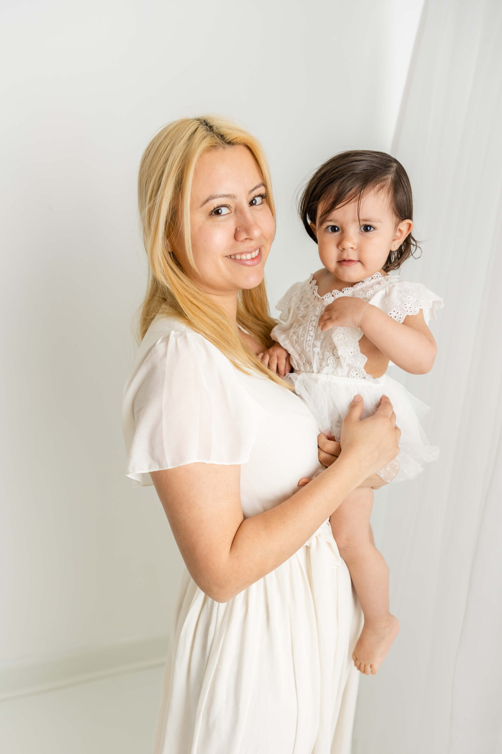 Close up image of mom and her adorable baby girl during their studio motherhood session.