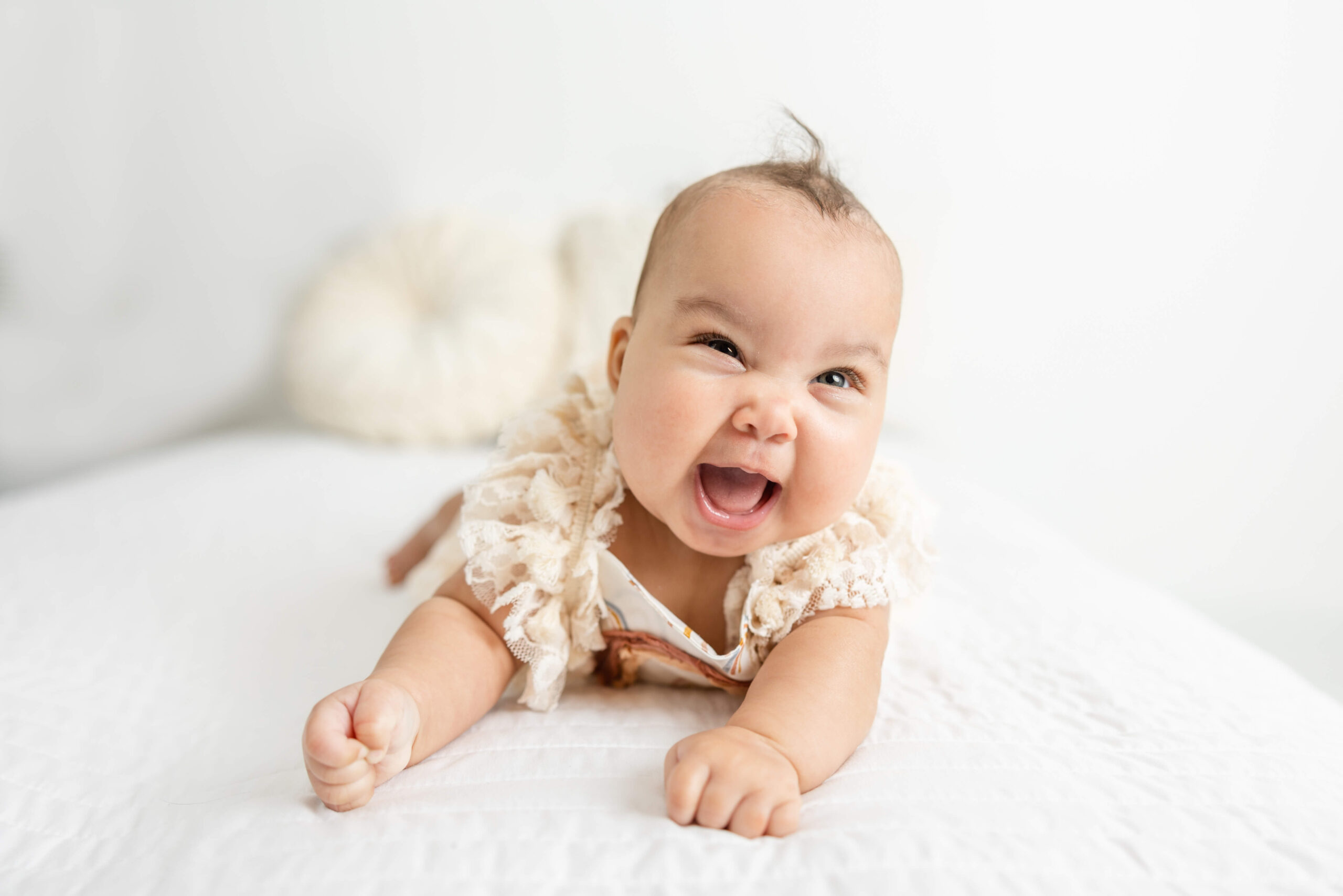 One happy little girl showing her smiles during her in studio motherhood session with Molly Berry Photography.
