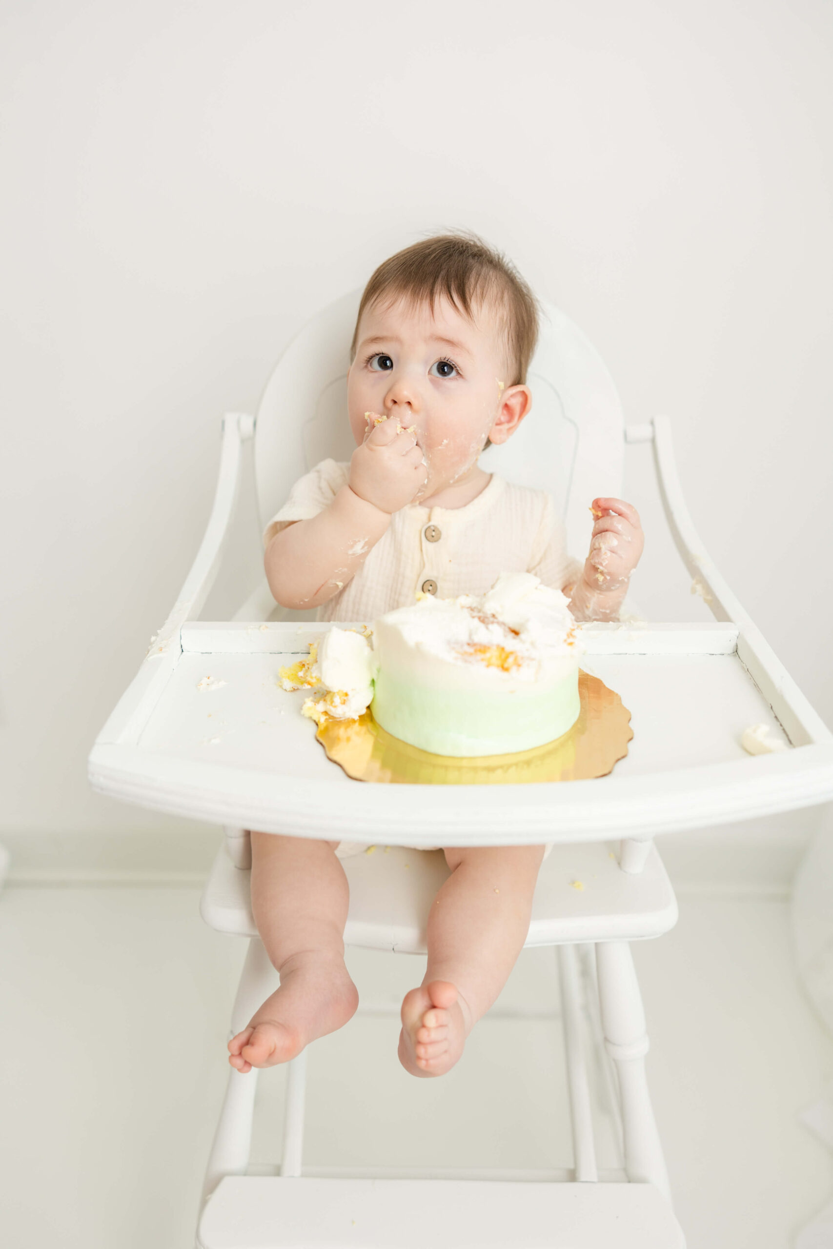 Eating cake one fistful at a time was captured by Molly Berry Photography during this little boys cake smash session. 