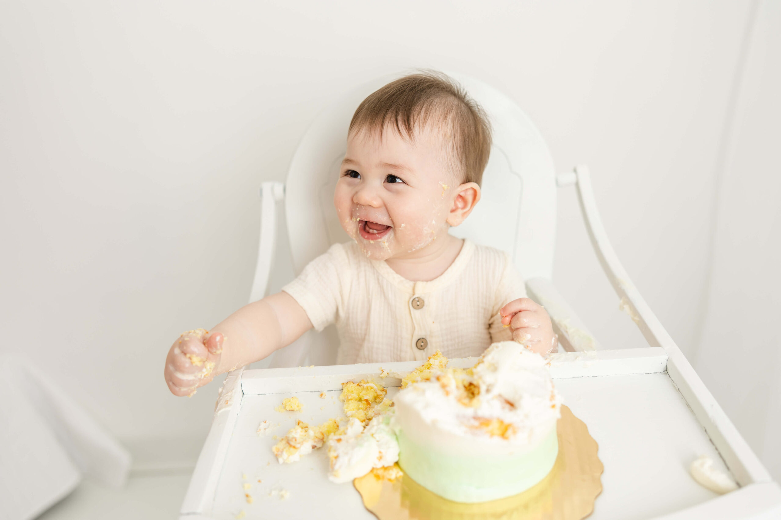 Smiles were captured from this little man while enjoying his cake during his cake smash session.
