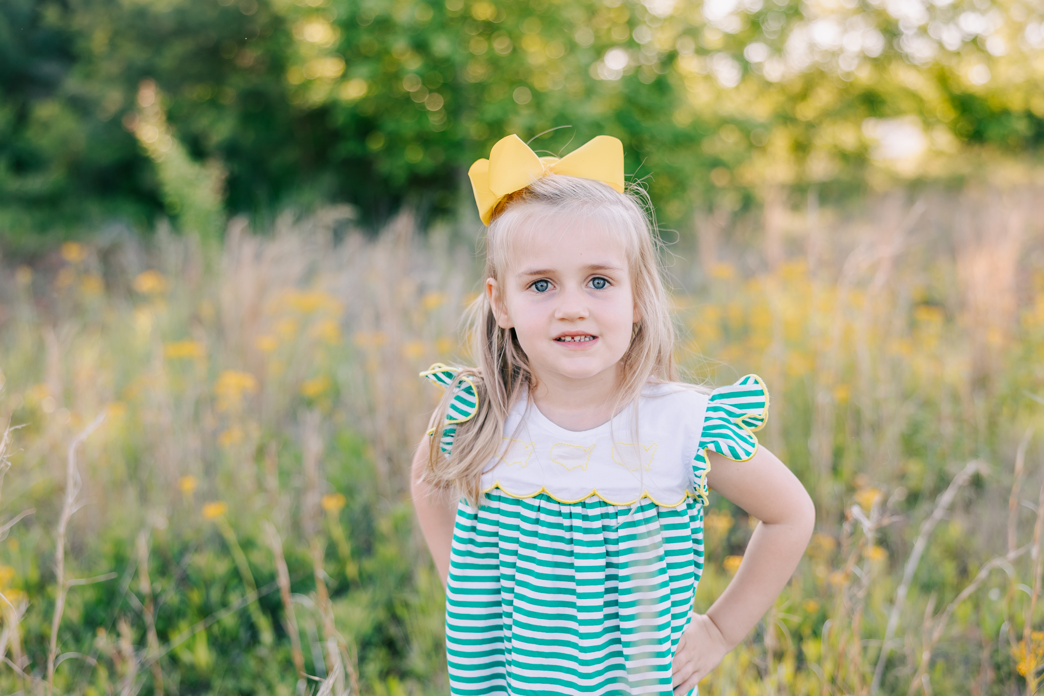 5 year old girl wearing a Little Bear Smocks green and white dress during her session with molly berry photography