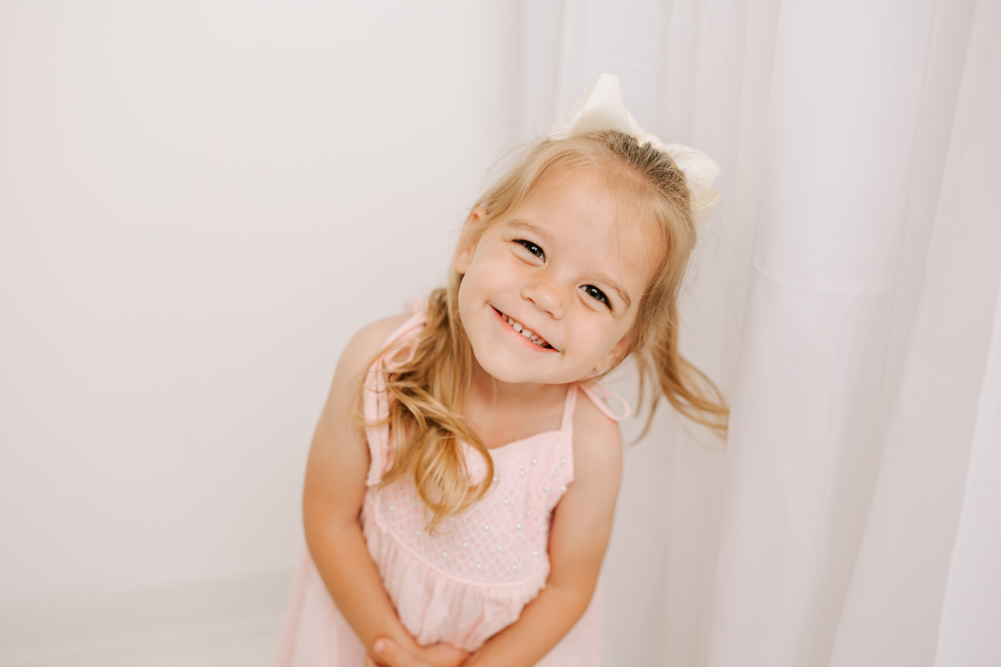 Three year old girl celebrating finishing the school year with a milestone session in the studio of molly berry photography