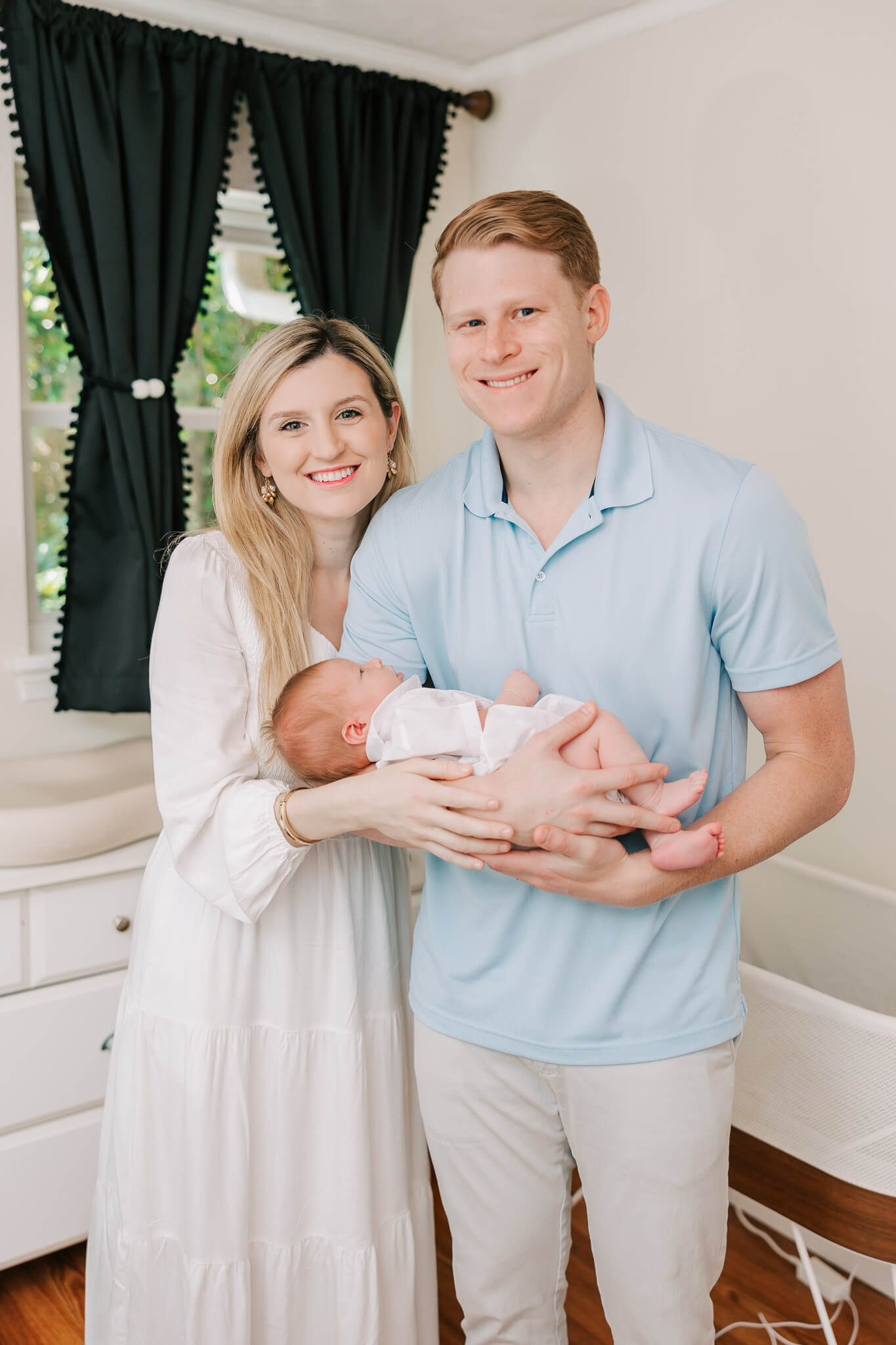 Family of three sharing a smile during their newborn session in Columbia, SC. Mom delivered at a Birth Center in Columbia SC