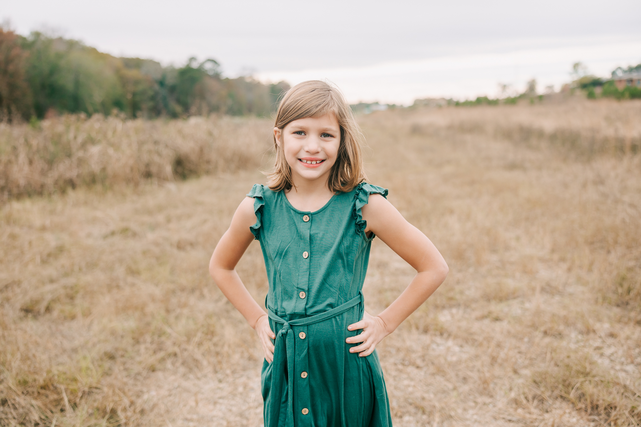 Smiling girl captures a portrait during her augusta family session.