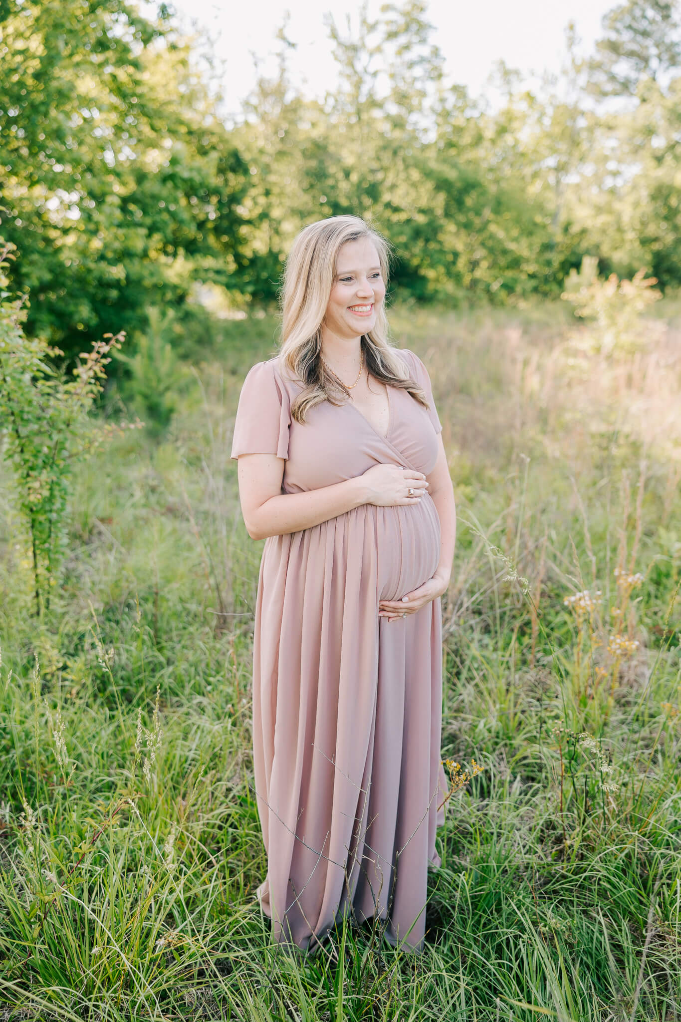 Expecting mom holding her belly during her maternity session in Evans Georgia. Mom has used Delightful toppings before for all her cookie needs. 