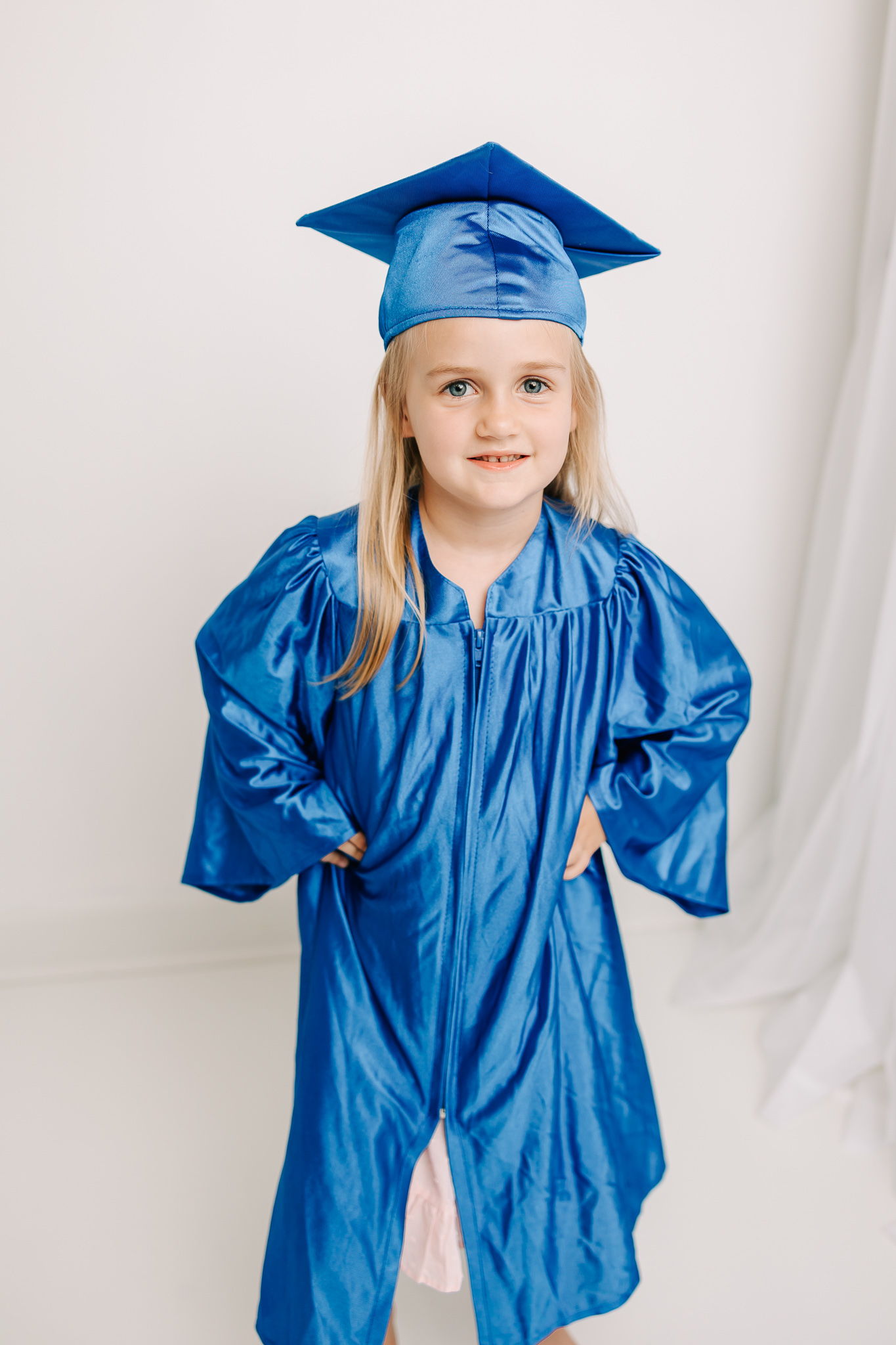 Little girl celebrating her preschool graduation with a session with molly berry photography.