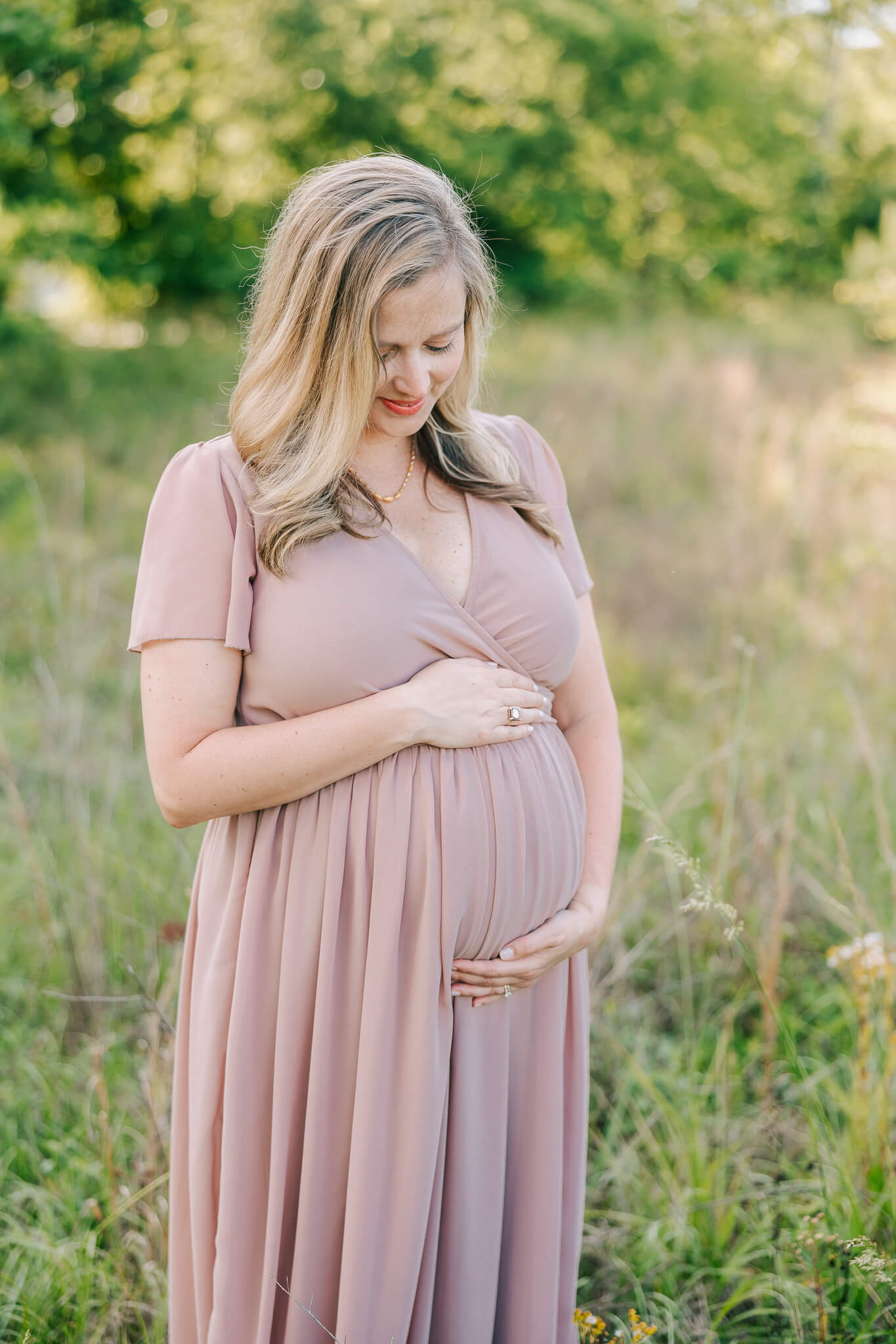 Expecting mom holding her baby belly during her columbia sc maternity session. Mom is using a Midwives Columbia SC for her birth.