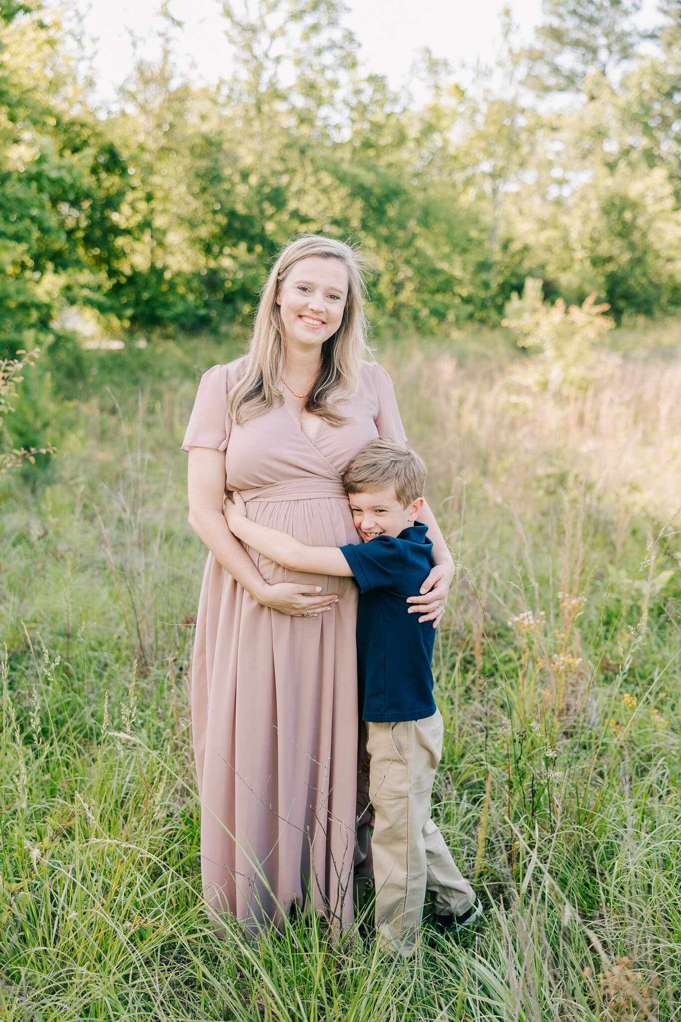Expecting mom and her son sharing a hug during their columbia sc maternity session. Mom is using a Midwives Columbia SC for her birth.