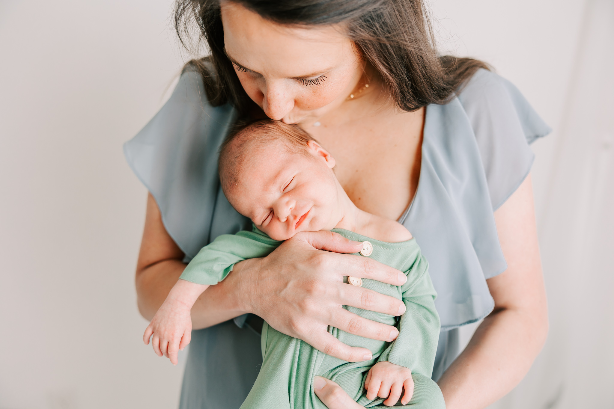 New mom holding baby boy during their in studio newborn session with molly berry photography. Mom used Placenta Encapsulation Columbia SC