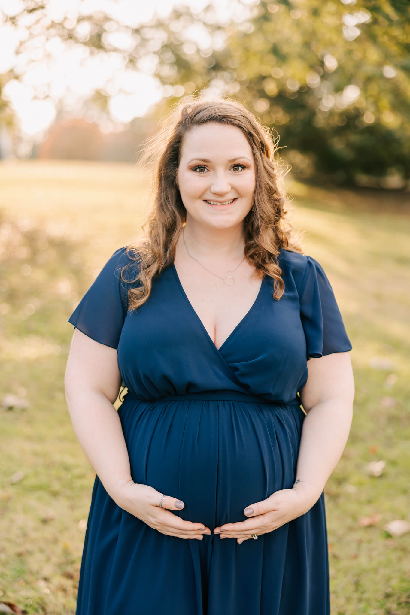 Soon to be mom showing off her baby bump during her columbia sc maternity photography session. Dress is provided by molly berry. Client used Stork Imaging Lexington SC for her gender reveal ultrasound.