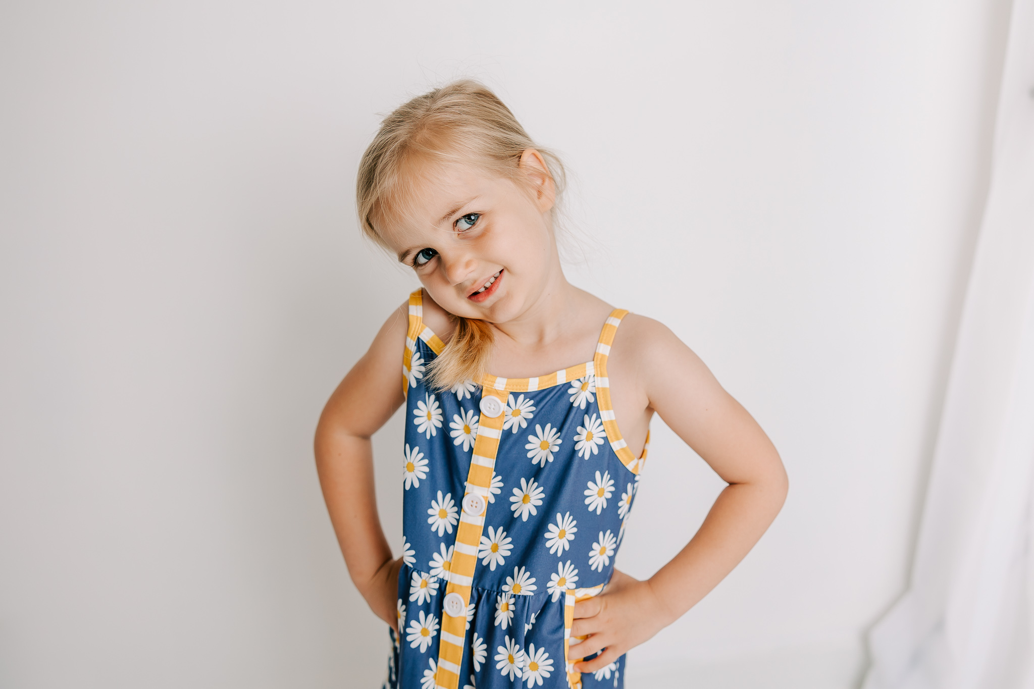 Sweet girl showing off her new dress she received from Sunshine Savvy Children's Boutique