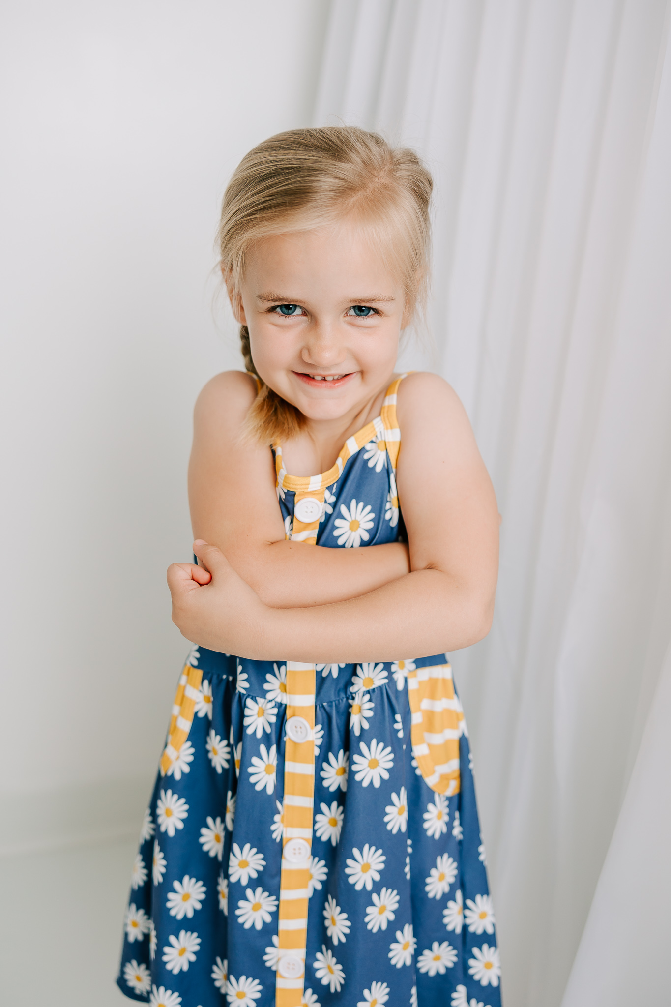 Five year old girl wearing her Sunshine Savvy Children's Boutique dress during her birthday milestone session with Molly Berry Photography