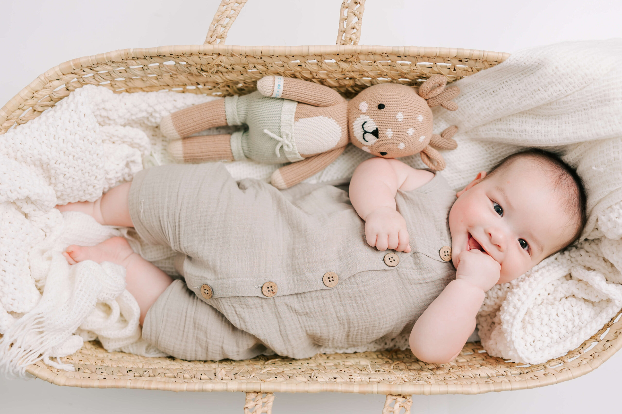 6 month old baby boy enjoying laying in his basket during his photoshoot.