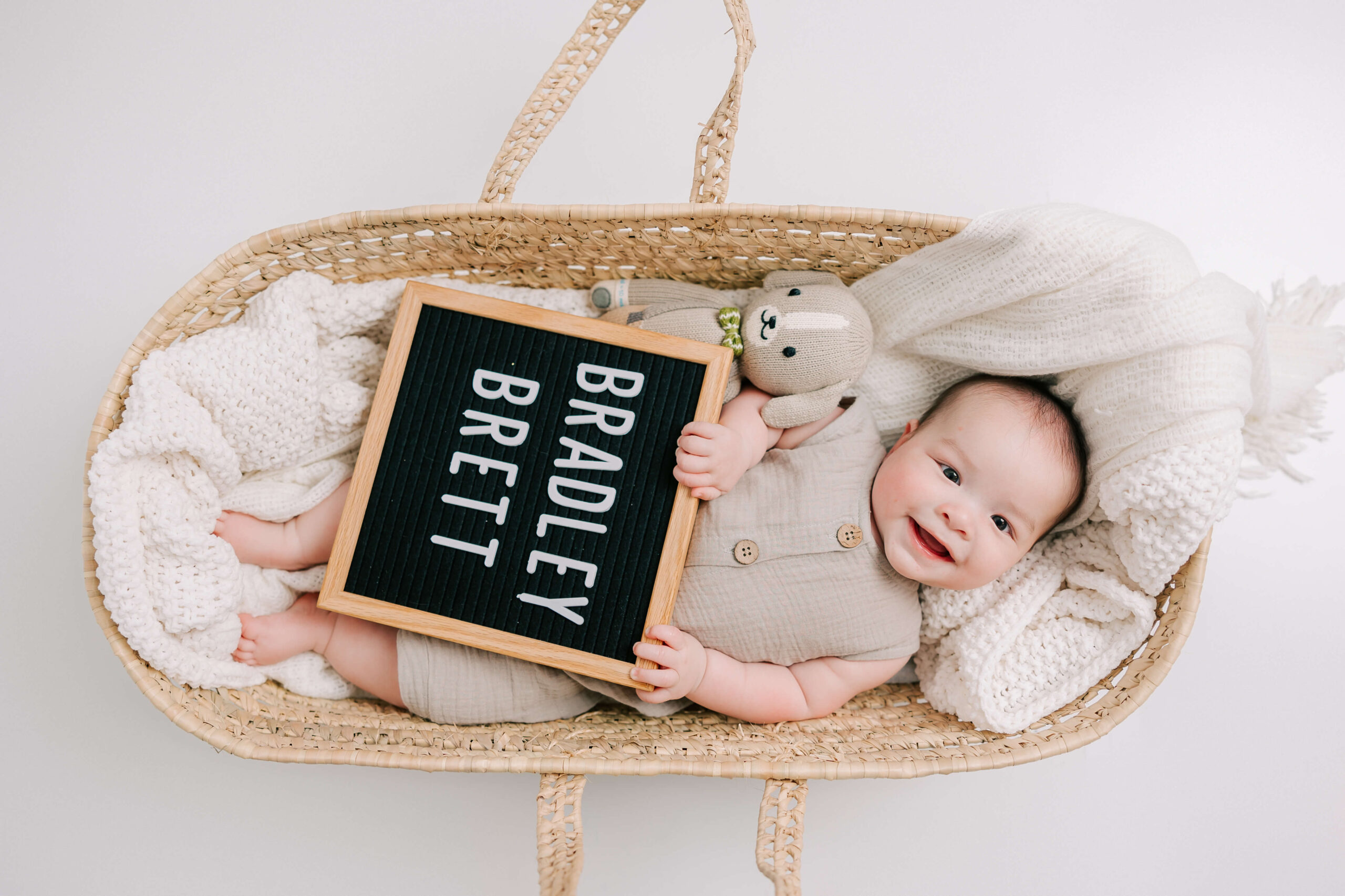6 Month old baby boy in bassinet during his augusta milestone and family session.