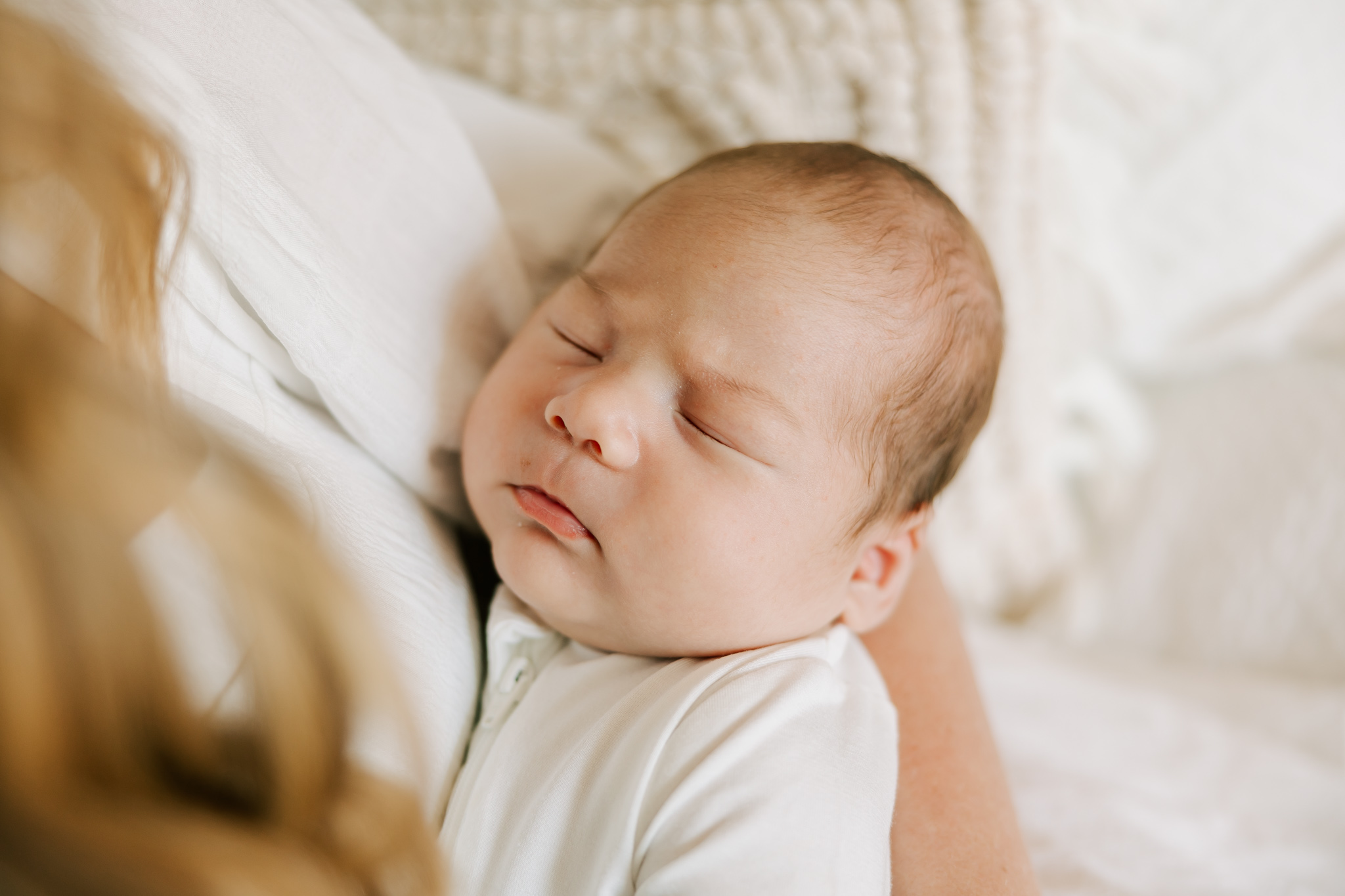 Close up of baby boy sleeping in moms arm during their newborn session in Columbia. SC with Molly berry your columbia newborn photographer