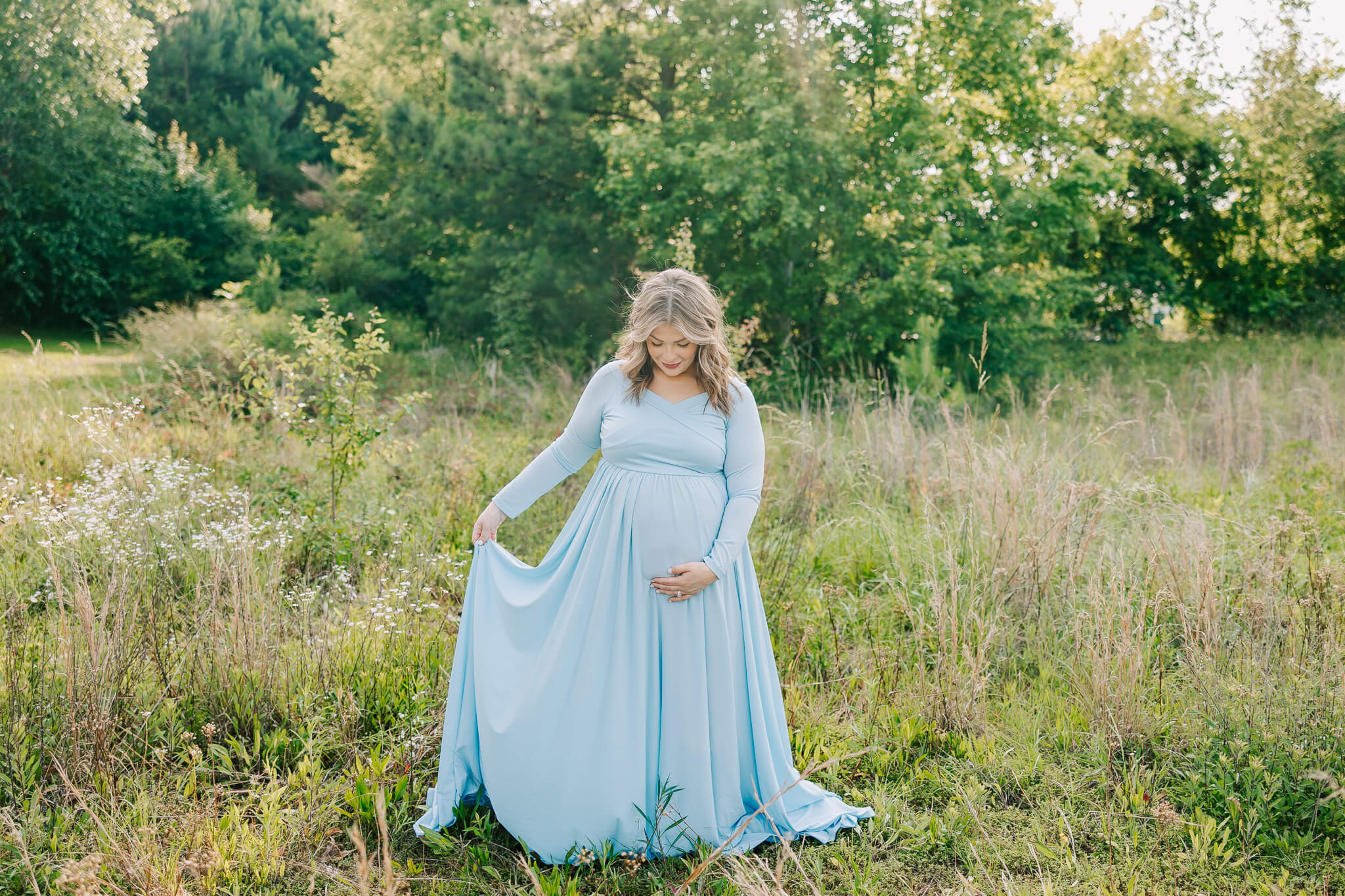 Expecting mom walking through a field during her atlanta maternity photography session. Mom is having her birth at the Atlanta Birth Center.