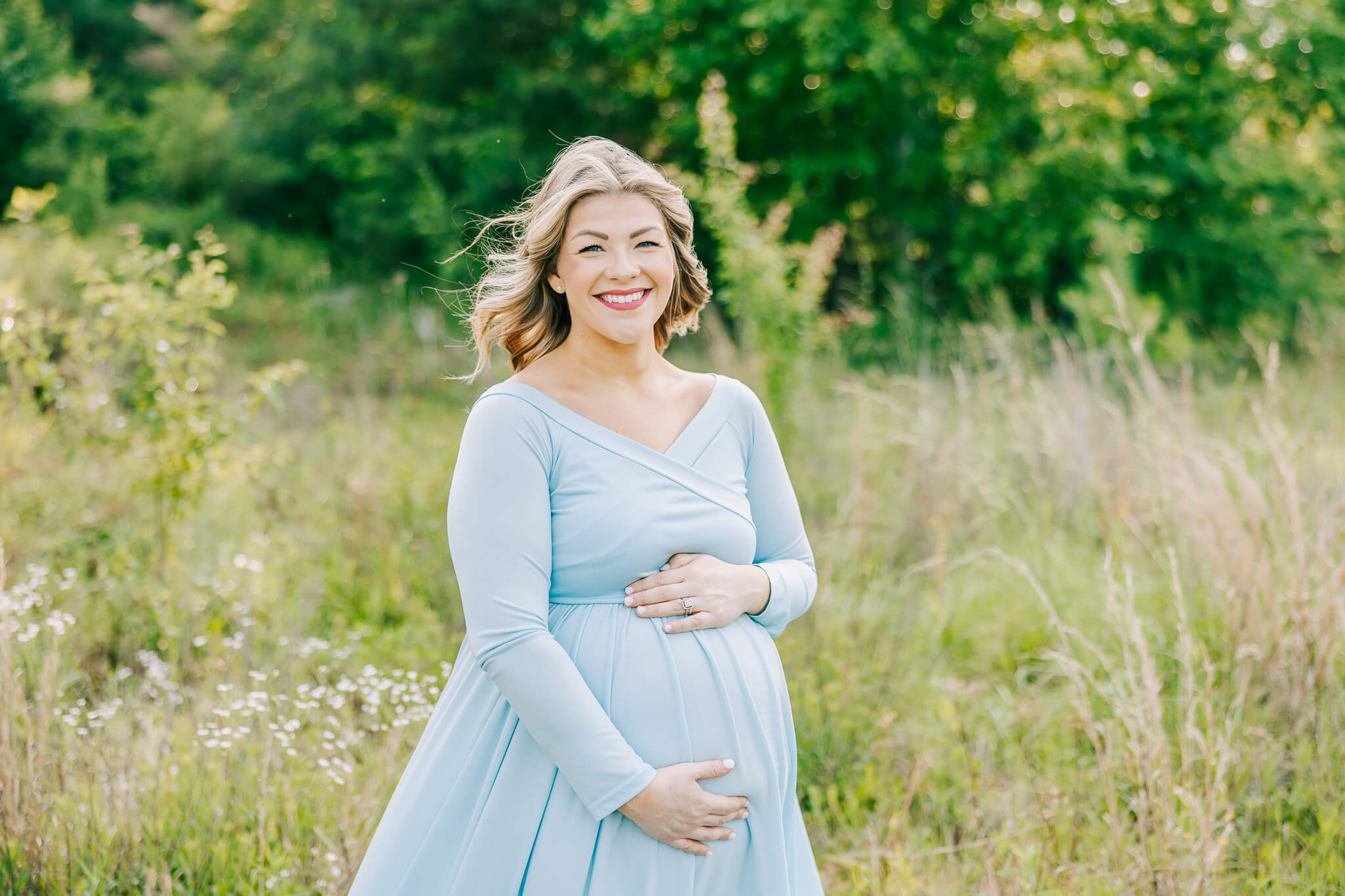 Expecting mom wearing a light blue dress during her atlanta maternity session with molly berry photography.